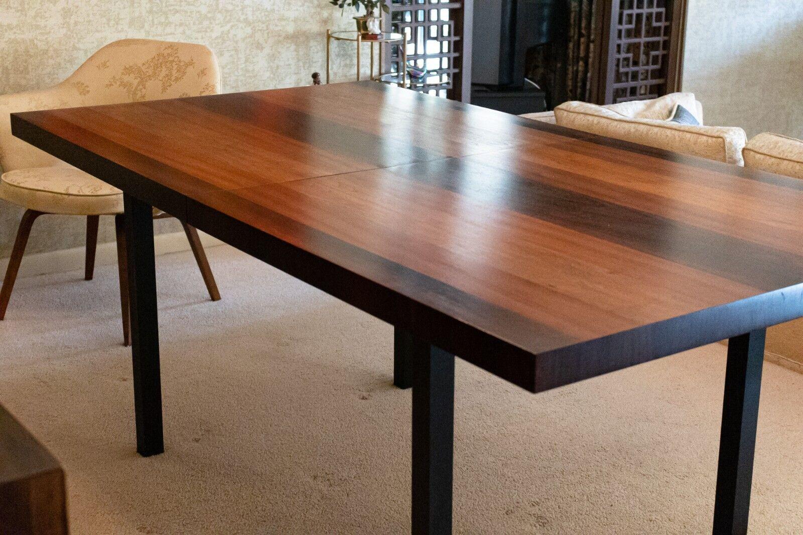 A wonderful for Directional Milo Baughman dining table made in alternating strips of rosewood, maple and walnut wood. This piece is in amazing vintage condition. It has been kept in great condition. It features a beautiful gradient of wood on the