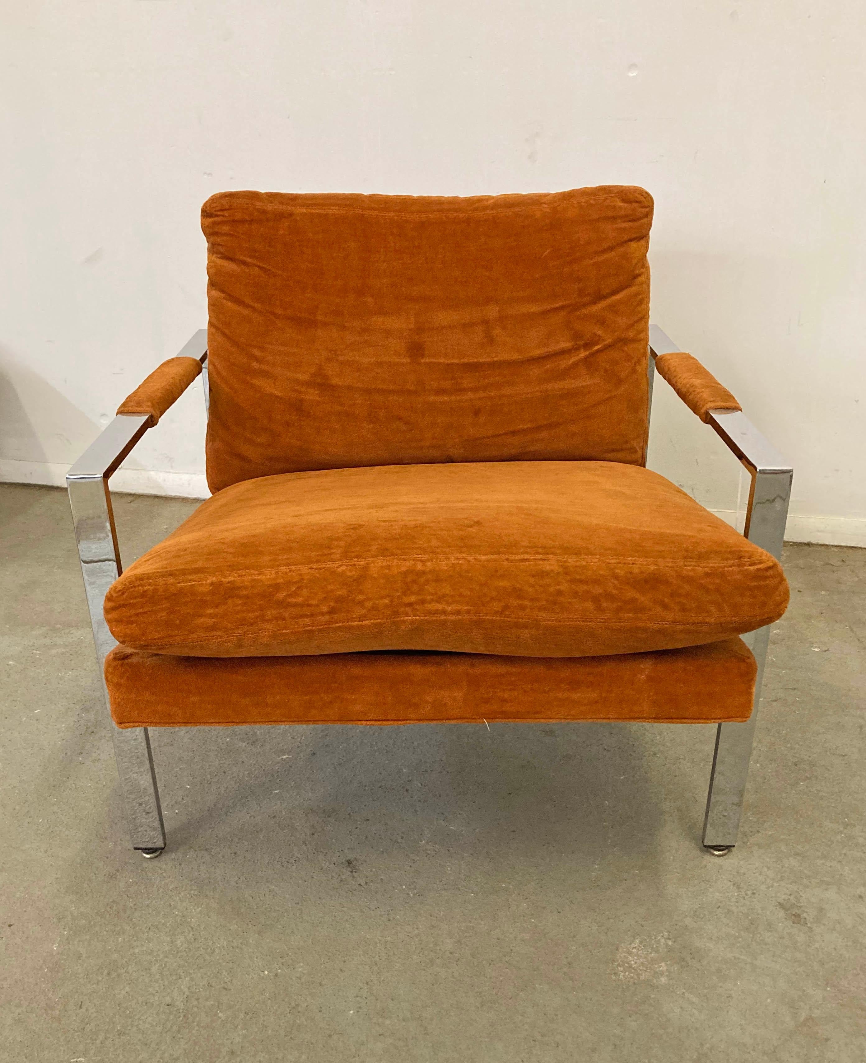 What a find. Offered is a vintage Mid-Century Modern lounge chair, designed by Milo Baughman for Thayer Coggin. This piece has a chrome base with orange velvet upholstery. It is in vintage condition showing some age wear including slight stains on