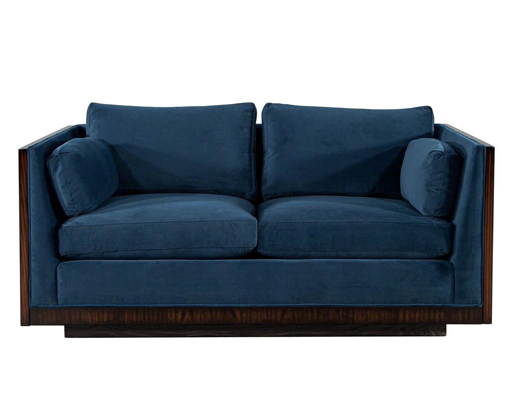 Mid-Century Modern Milo Baughman loveseat sofa. Iconic mid-century modern design by Milo Baughman. America, circa 1960’s. Masterfully restored in a rich high gloss polished finish with dark navy soft to the touch fabric. Beautiful, detailed wood