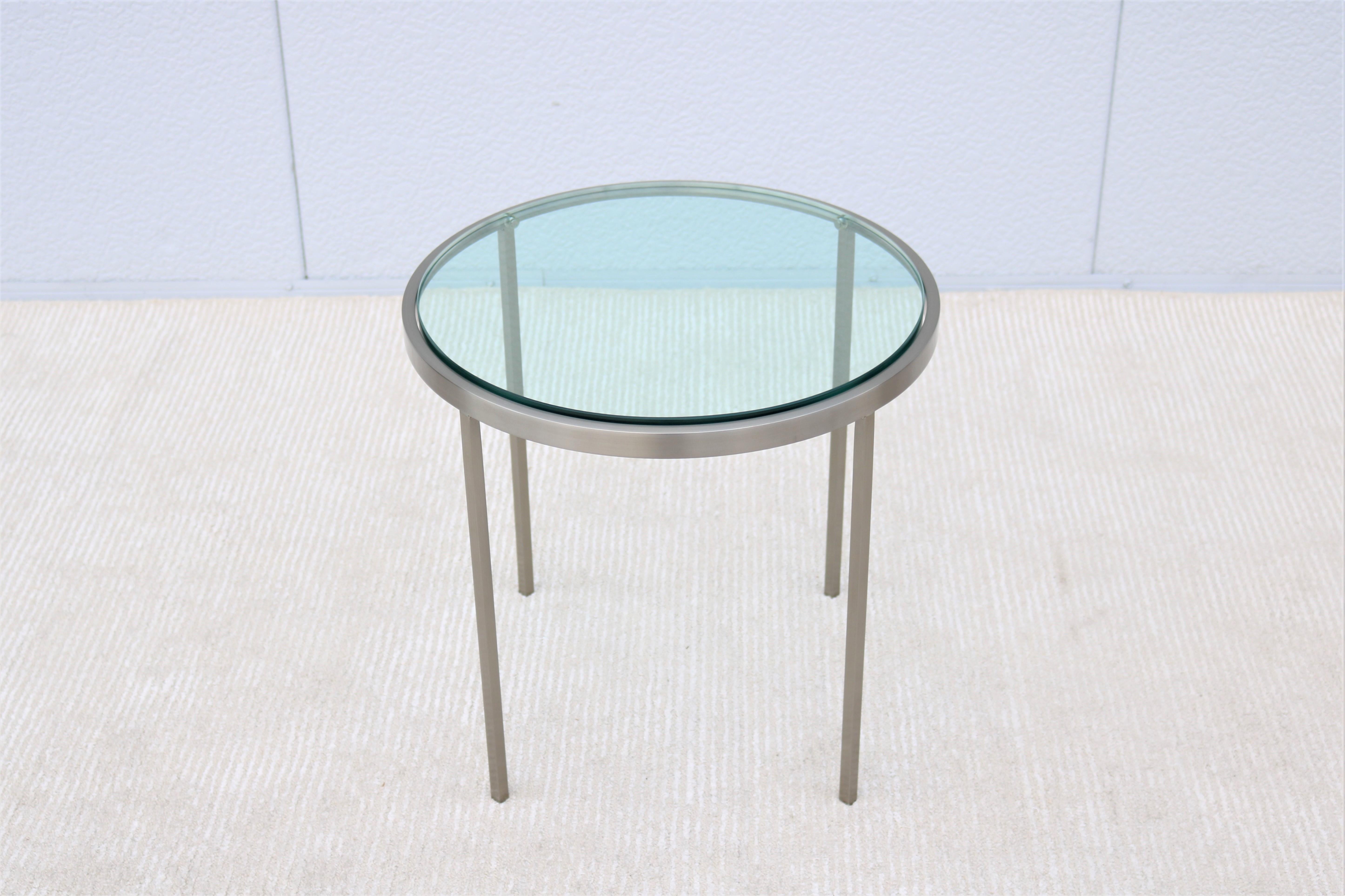 A stunning minimalist and elegant looking Mid-Century Modern Milo Baughman style side end table.
Features a circular stainless-steel frame holding an Inset glass top supported by four square tubular legs.
The minimalistic design with simple clean