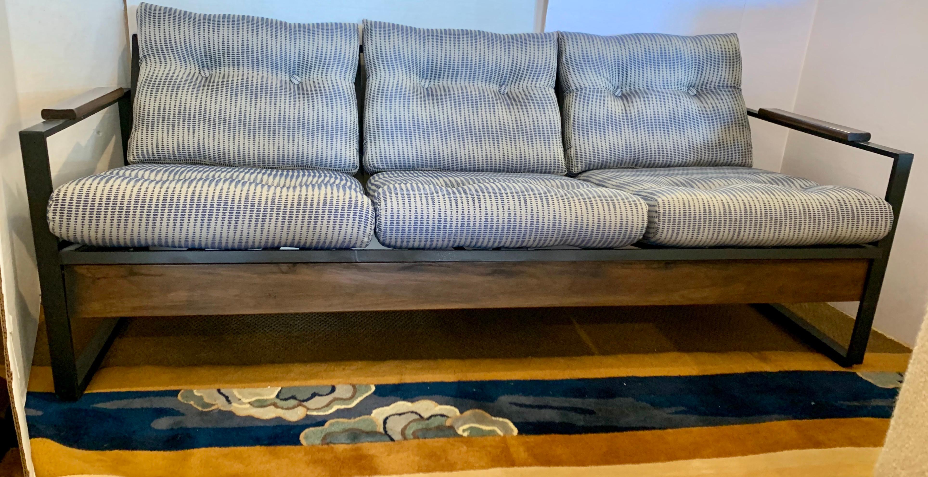 Newly reupholstered Milo Baughman style sofa that measured just under six feet wide and sits three people. An iconic midcentury piece that features a blue and off-white color scheme on the fabric and black metal and wood on the frame. What makes