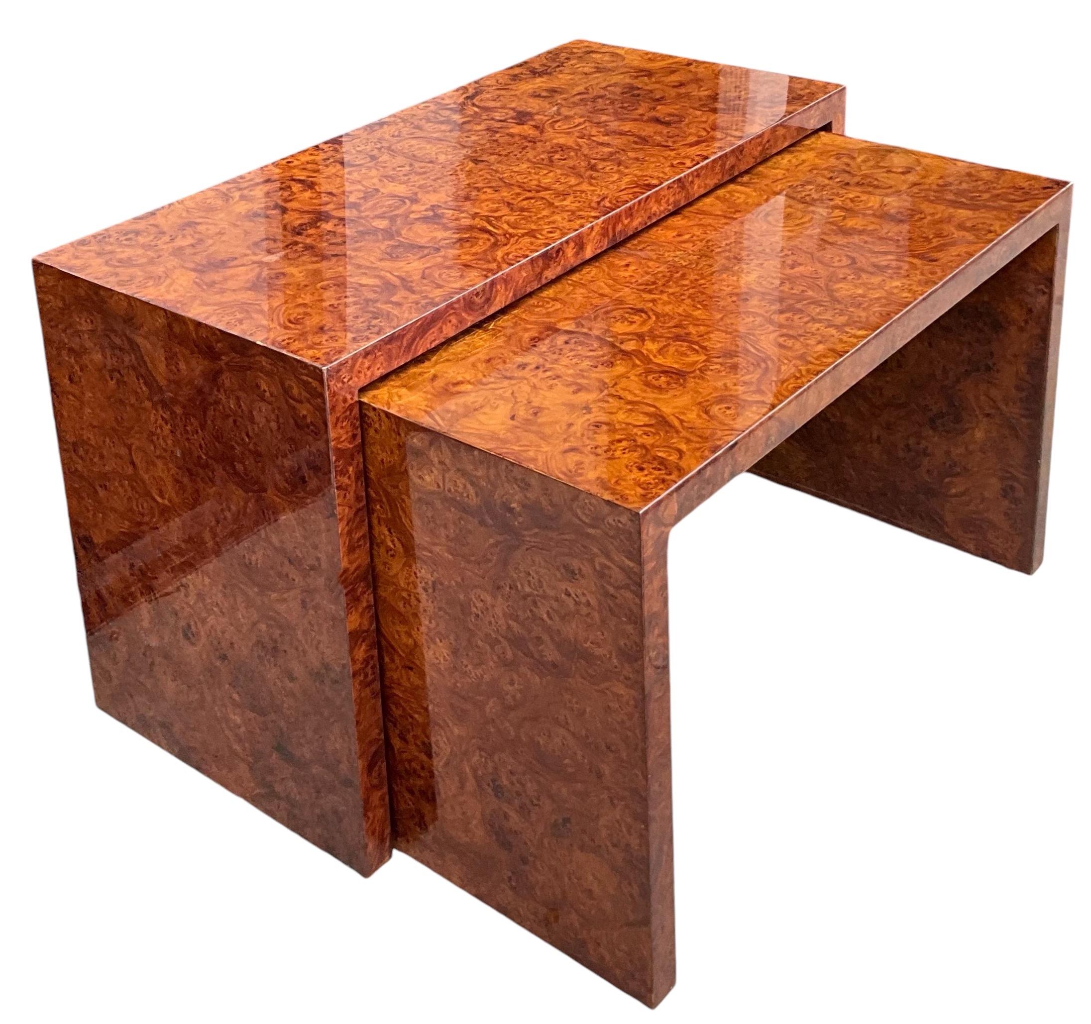 I really like this set because it is unusual to find nesting console tables. Their modern styling is reminiscent of the famous furniture designer, Milo Baughman. They are burlwood with a high gloss finish. They most likely date to the 70s and are