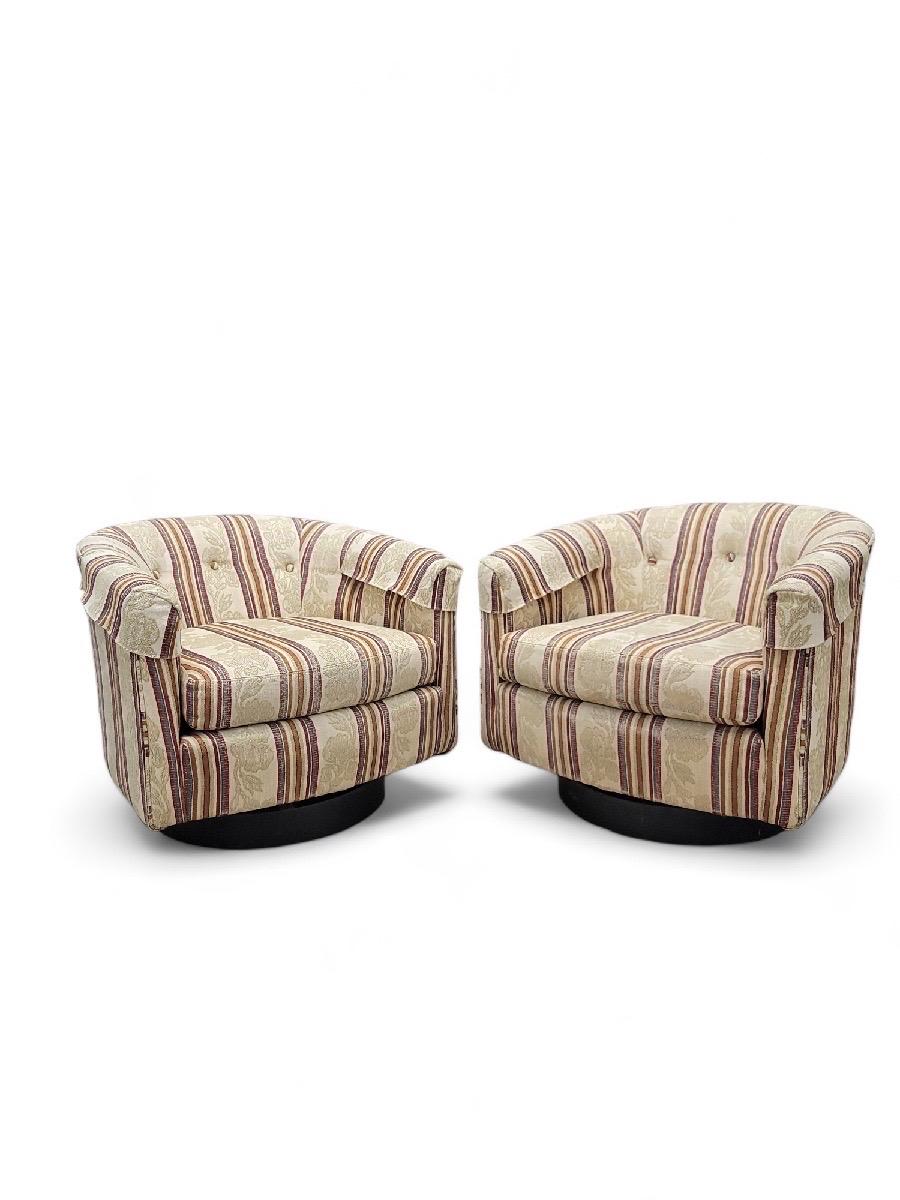Mid Century Modern Milo Baughman Style Ebony Wood Base Swivel Tub Chairs - Pair 

This pair of swivel chairs remain in their original upholstery. Perfect for you modern space, provide your guests with ultimate comfort. 

Items do not have a maker's