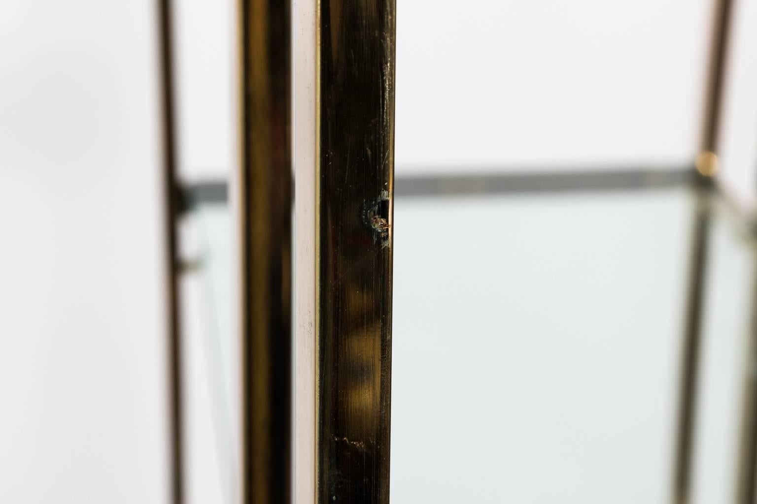Modern Milo Baughman style brass etagere with five glass shelves, circa mid-20th century.
 