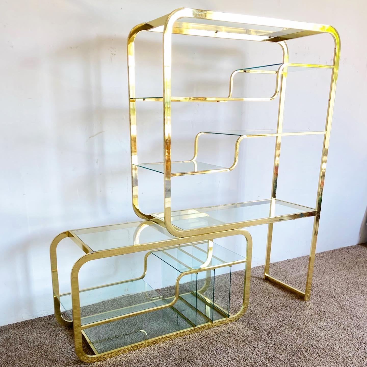 Here it is, the coveted expandable golden Etagere. Features several glass shelves with inserts on the bottom shelf. Displays a fantastic sculpted motif throughout the item.

Extends to 85”W.