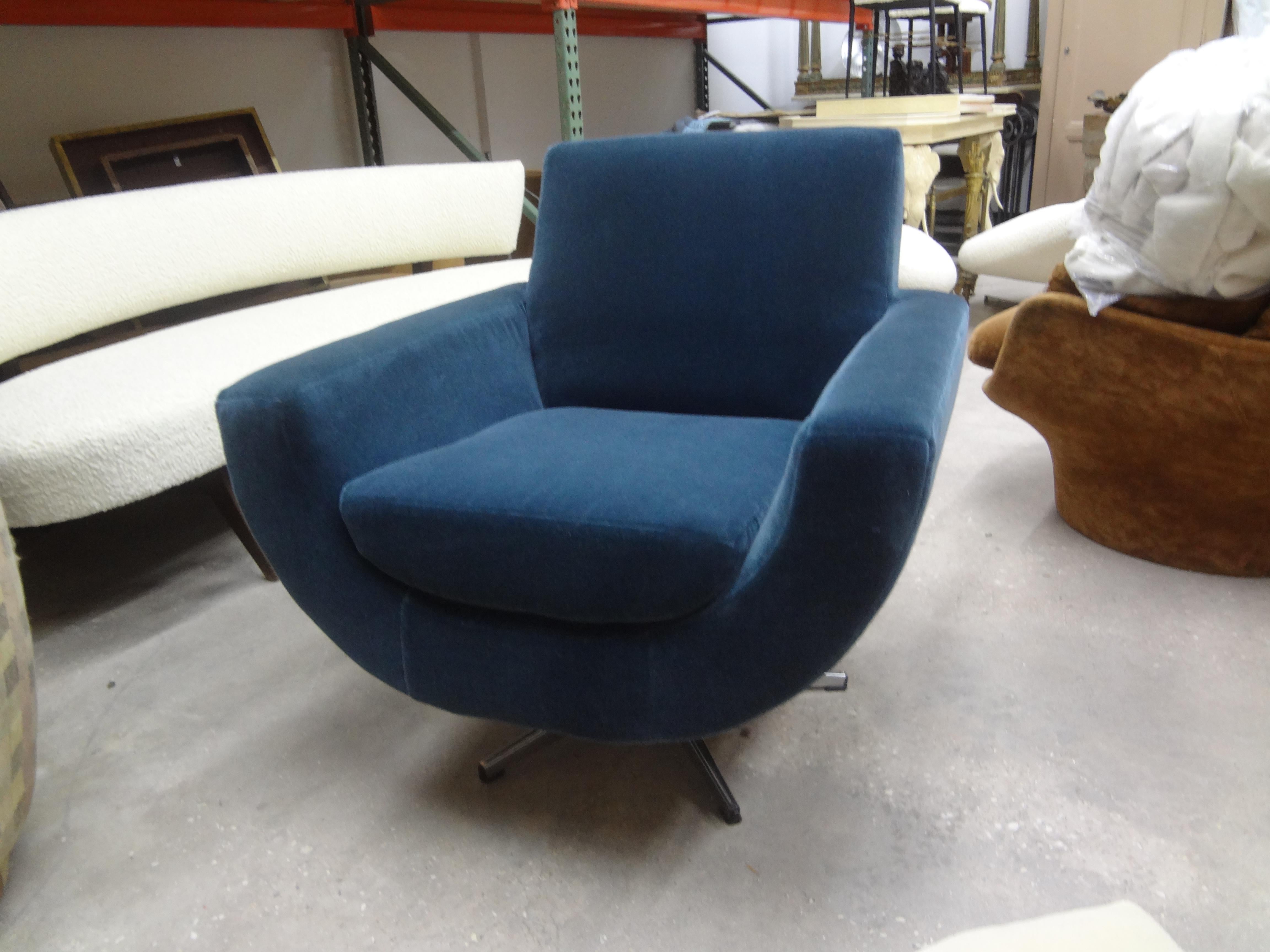 Mid-Century Modern Milo Baughman style swivel chair. This shapely midcentury swivel chair has been newly upholstered in a beautiful steel blue mohair fabric.
Comfortable and stunning from every angle!