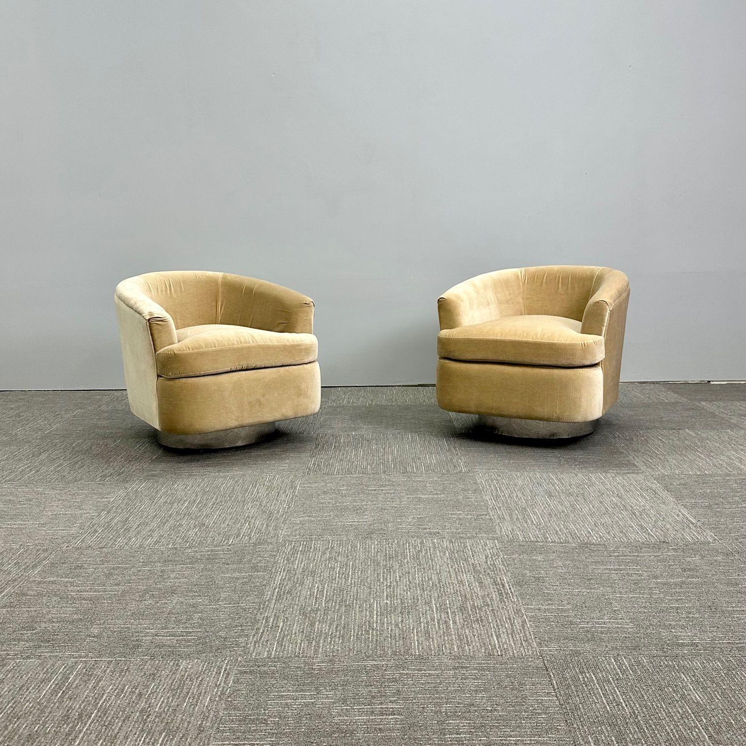 Mid-Century Modern Milo Baughman Style Swivel Chairs, Chrome Base, Tan Mohair
 
Pair of modern Milo Baughman inspired swivel chairs having a chrome finished base and tan mohair upholstery. This chair sits about 3 inches off the ground and has a high