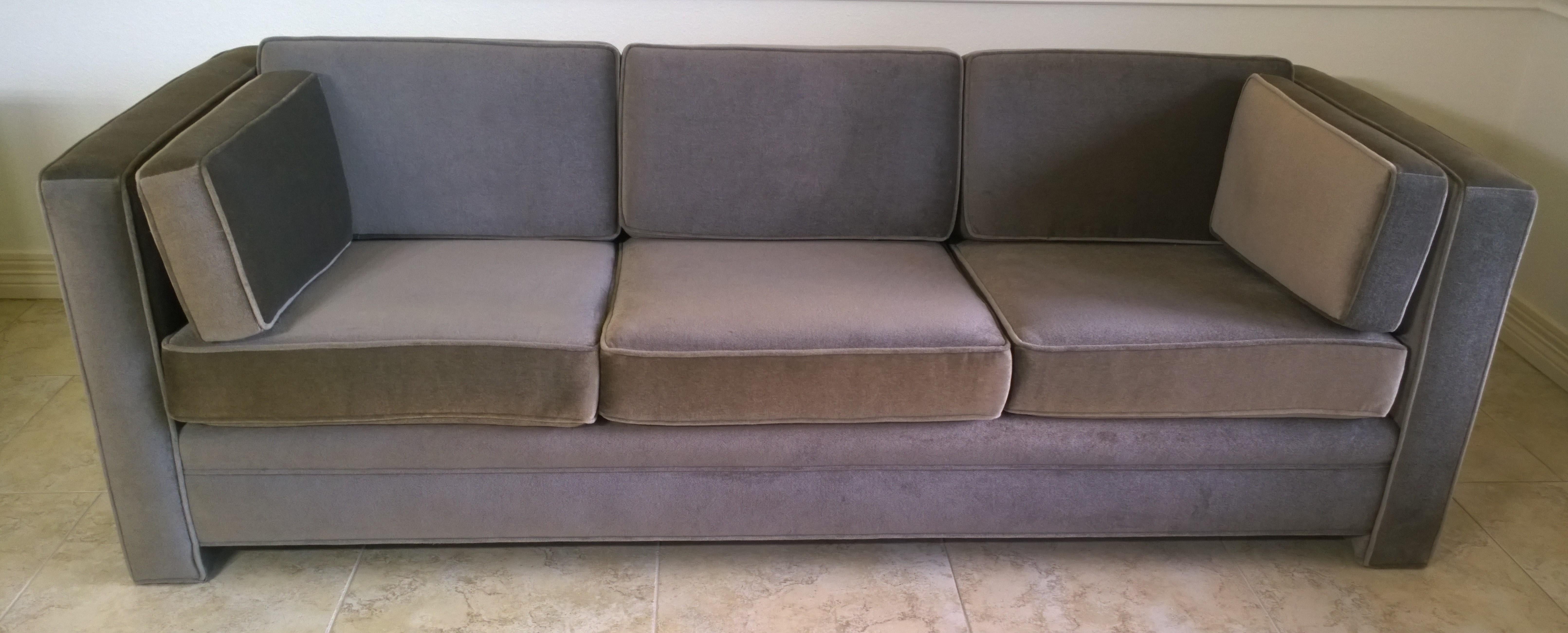 Offered is a Mid-Century Modern Milo Baughman style newly upholstered mohair wool tuxedo sofa in a warm gray color way. This piece is a three-seat sofa with three seat cushions and three back cushions and two armrest cushions. The sofa is quite