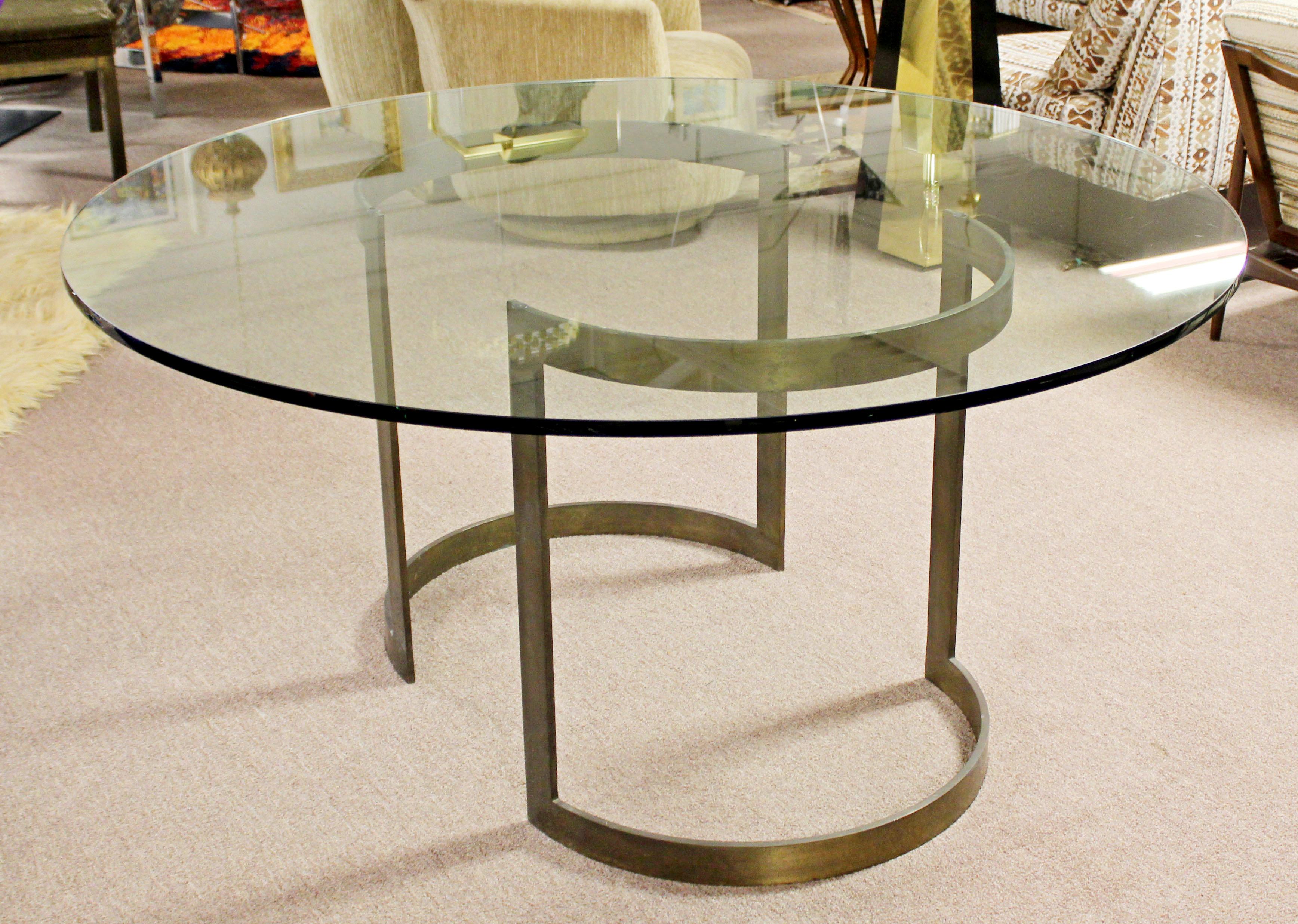 For your consideration is a stunning dining table, with two half moon bronze bases and a circular glass top, by Milo Baughman for Thayer Coggin, circa 1970s. In very good patinated condition. Base can also be used as a desk by putting a rectangular