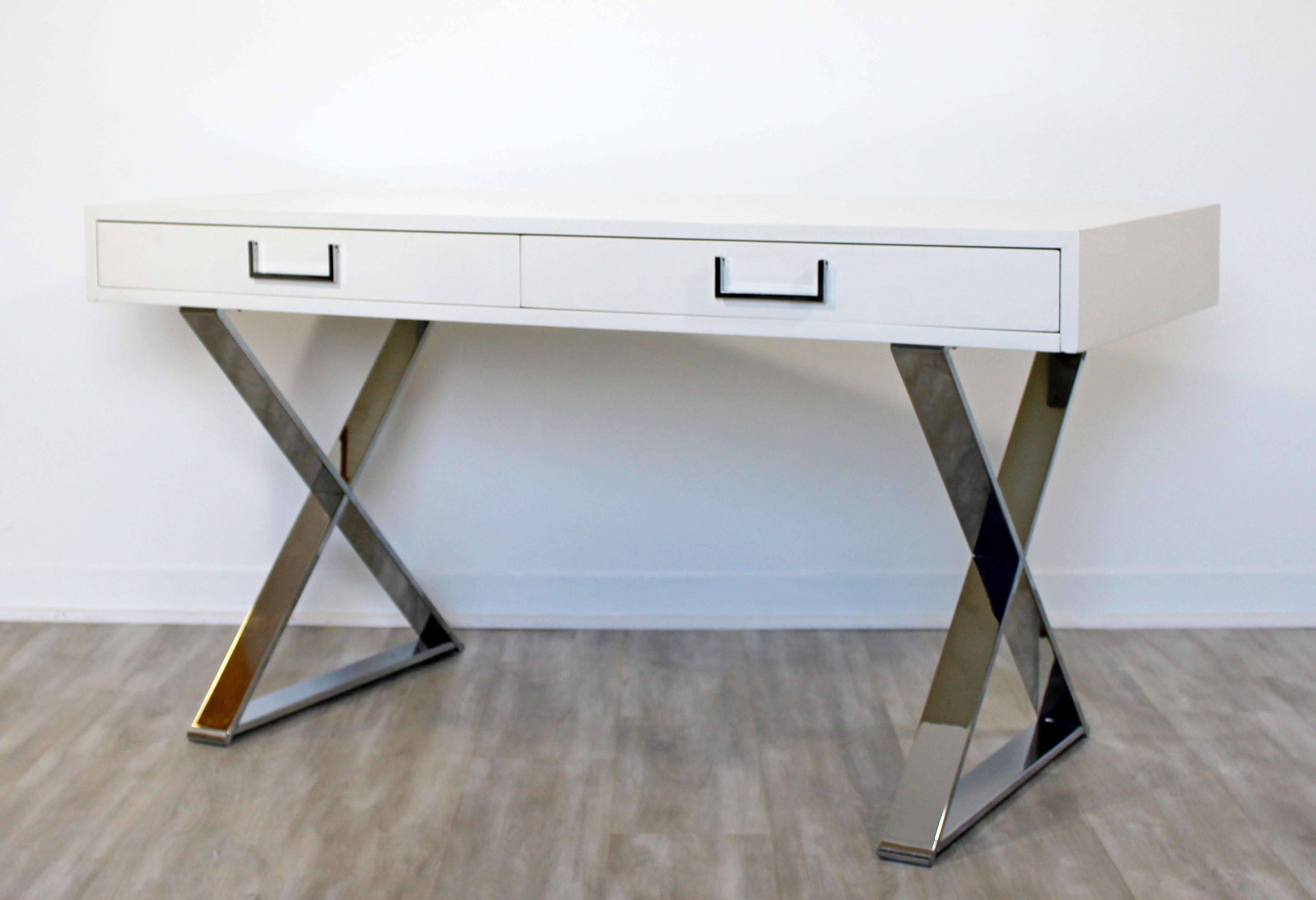 For your consideration is a vivid, white lacquered, Campaign desk, on chrome X bases and with chrome pulls, by Milo Baughman, circa 1960s. In excellent condition. The dimensions are 54