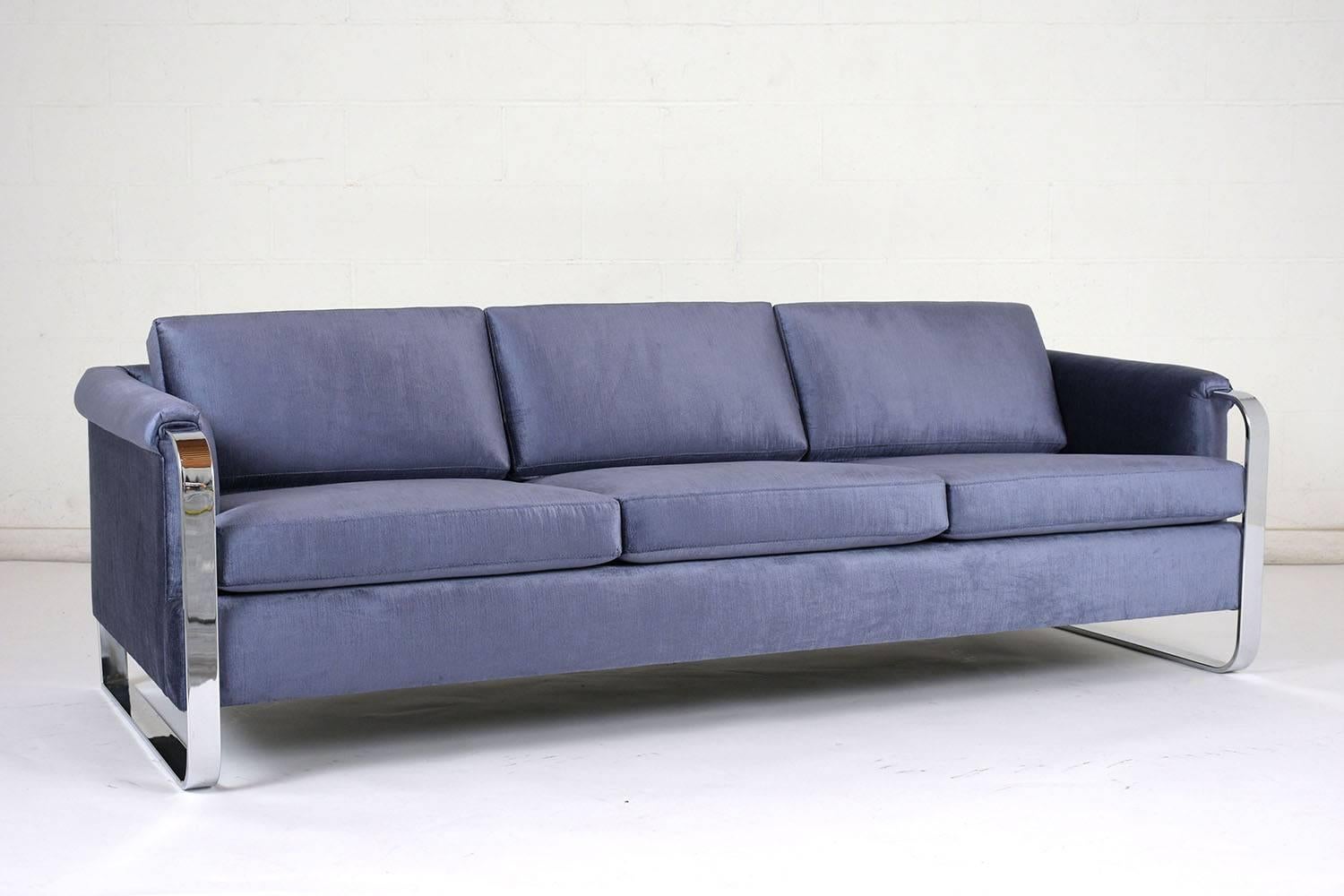 This 1960s Mid-Century Modern Sofa is designed by Milo Baughman has been completely restored and is upholstered in a new stunning royal blue color velvet fabric with new comfortable seat cushions. The sofa features a chrome-plated steel frame giving