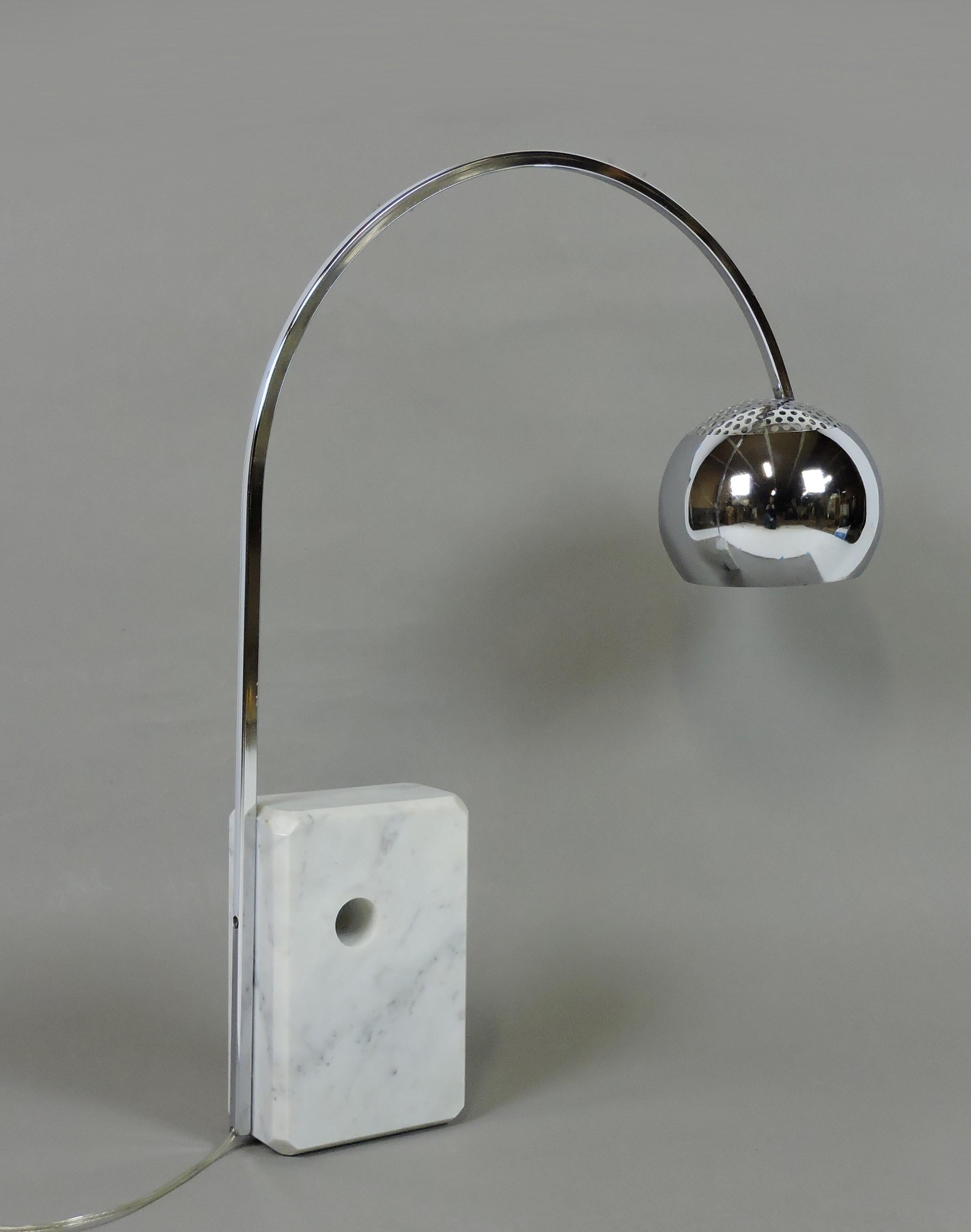Beautiful and hard to find mini version of the classic Italian Arco floor lamp designed by the Castiglioni brothers. This lamp has a polished beveled edge Carrara marble base and a chrome arc and shade. Takes a single standard base bulb and the
