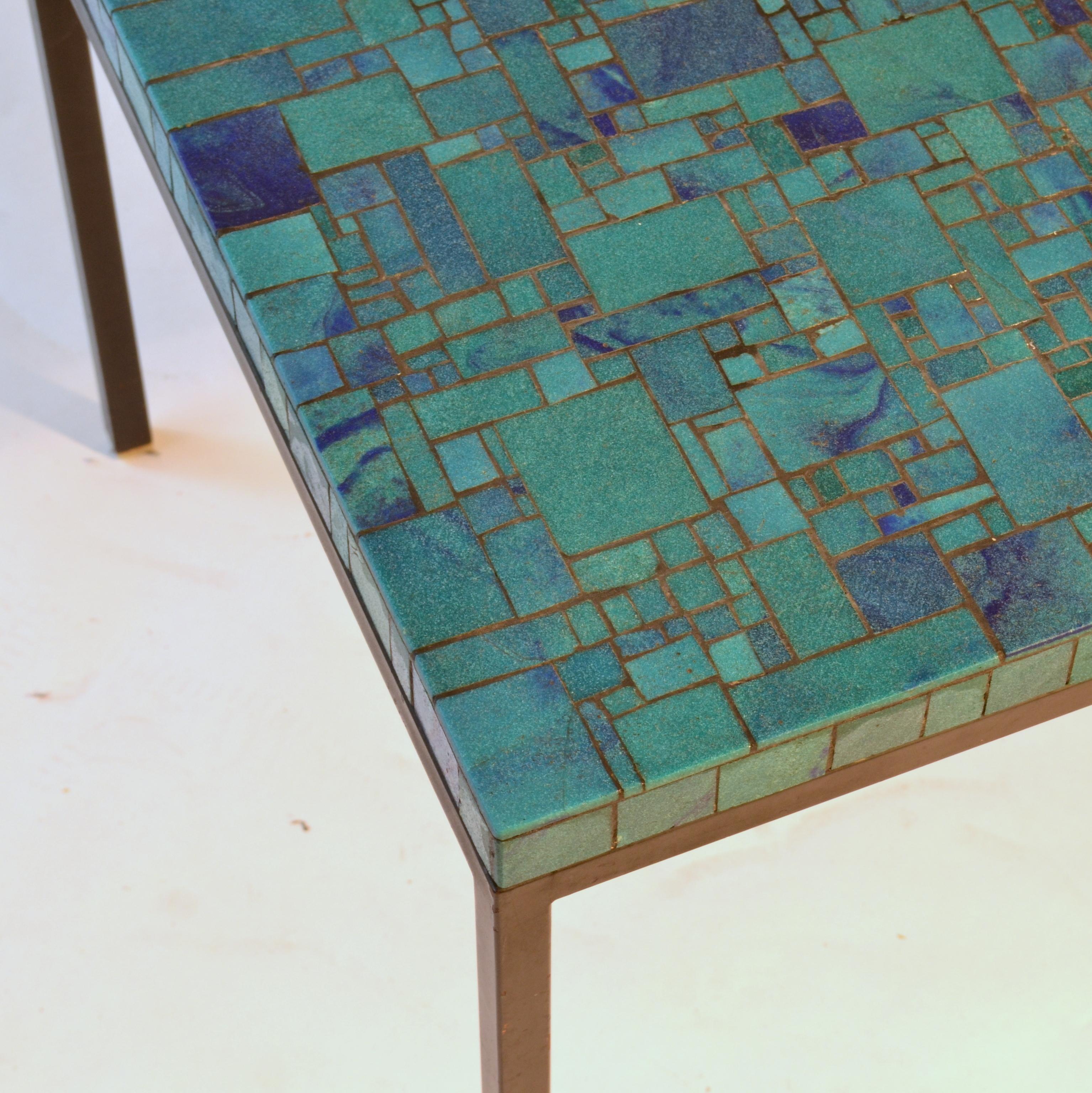Square turquoise glass mosaic coffee table on black metal frame. The coffee table is handmade of cast glass in different tones of aqua blue and individually cut in mosaic square and rectangle tiles. It is made in the 1960s in the manner of Muller