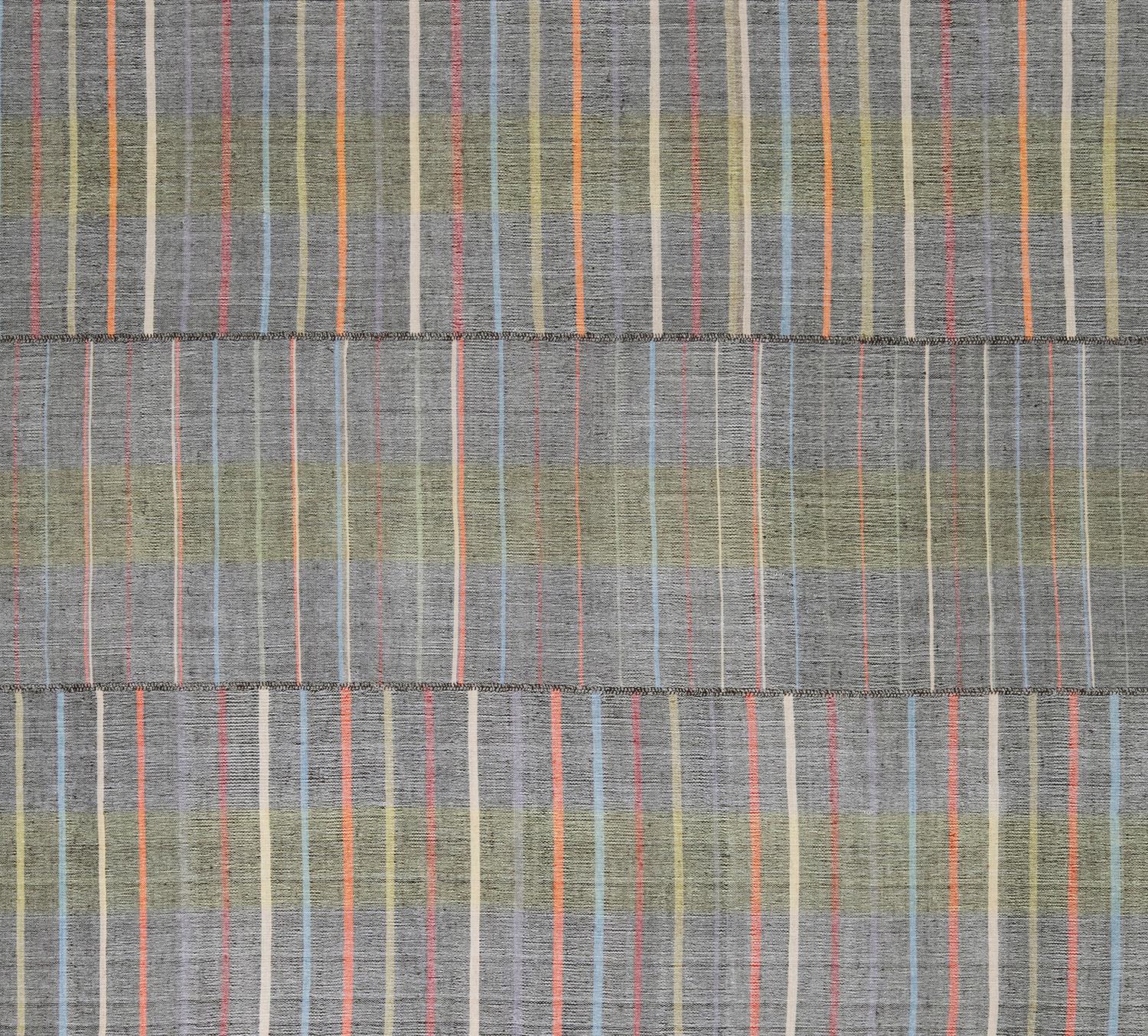 This beautiful grey with multicolor accented striped flatweave rug is made with handspun wool and cotton and natural dyes. It is inspired by the antique kilims that are native to the Kurdish region in Iran. NASIRI continues their rich tradition of