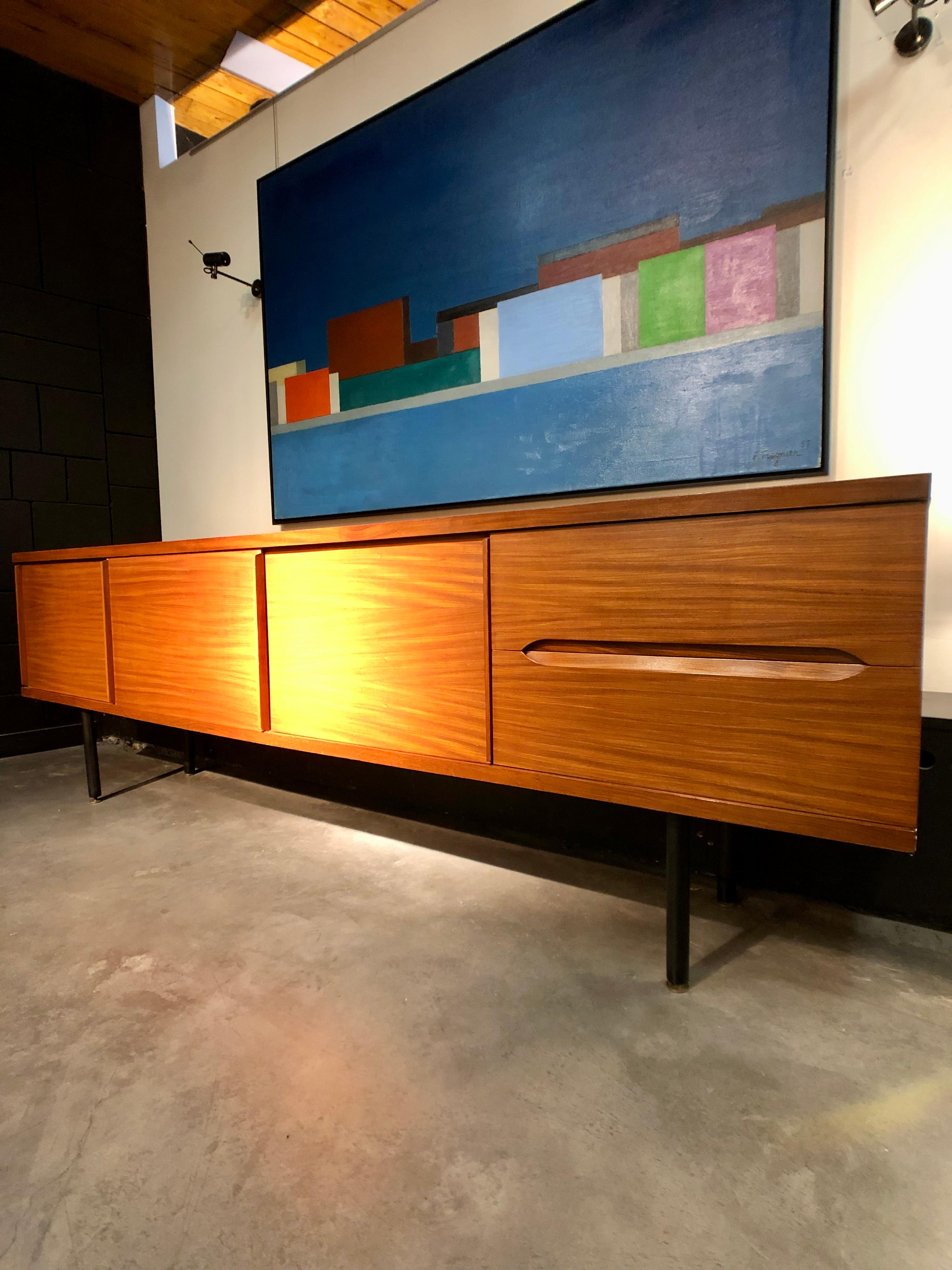 Side board with 3 sliding doors and 2 drawers on adjustable black lacquered metal and copper foot.
Branded Dal Vera on one side of a drawers.
Unusual design for Italian maker very simple and minimalist design.
Unknown designer but some details