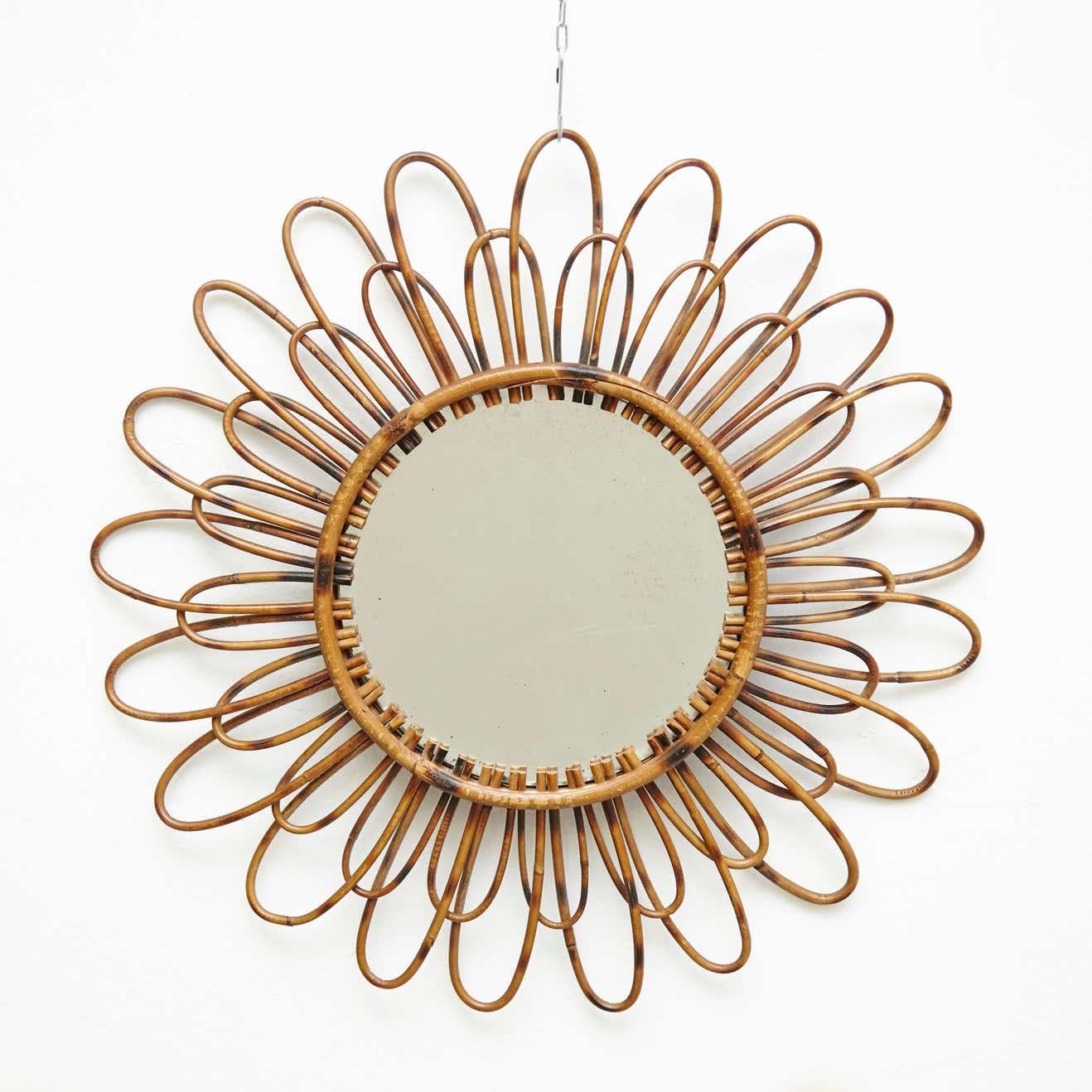Mid-Century Modern French Handcrafted Rattan Wall Mirror - Circa 1960

Add a touch of vintage charm to your home with this Mid-Century Modern French handcrafted rattan wall mirror, created by an unknown artisan circa 1960. Its unique design and