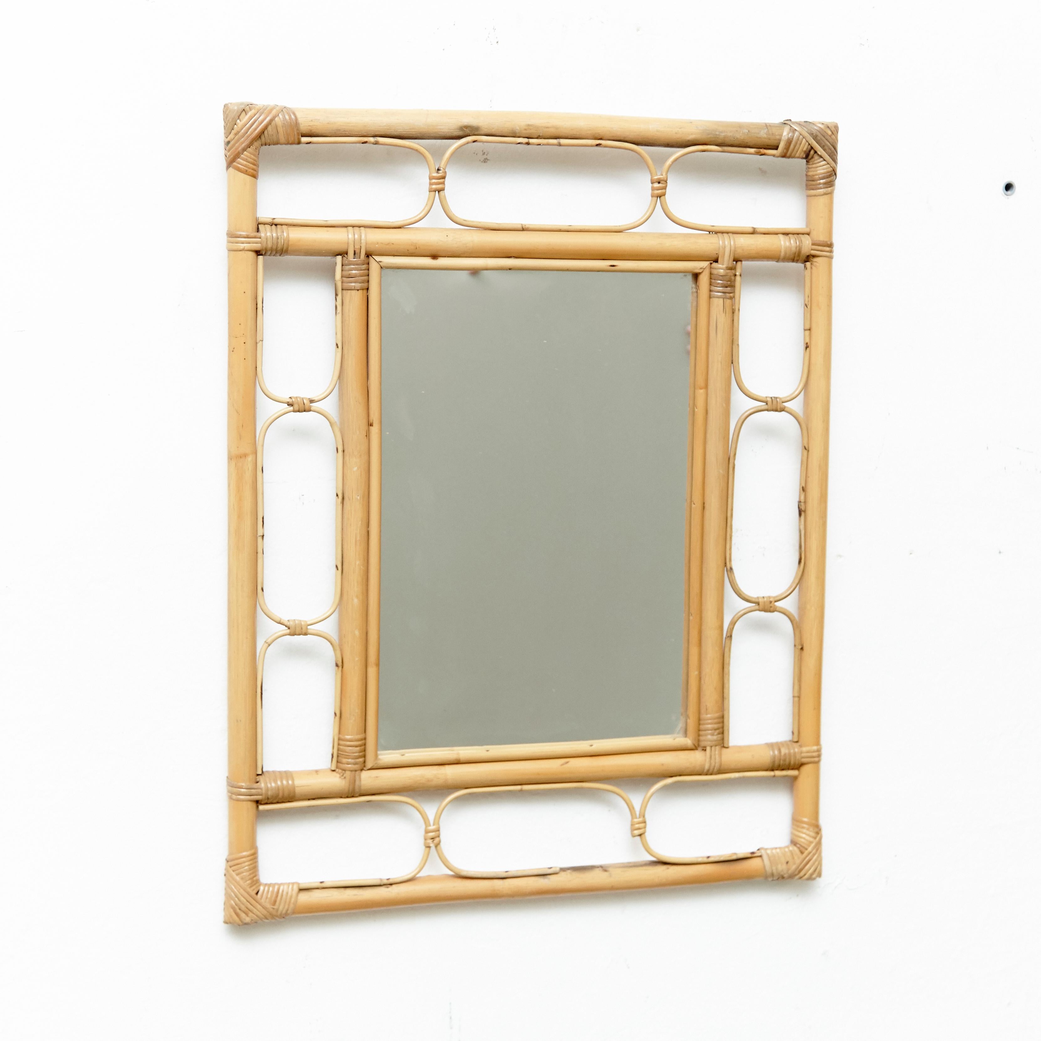 Mid-Century Modern mirror bamboo and rattan handcrafted, circa 1960
Traditionally manufactured in French.
By unknown designer.

In original condition with minor wear consistent of age and use, preserving a beautiful patina.