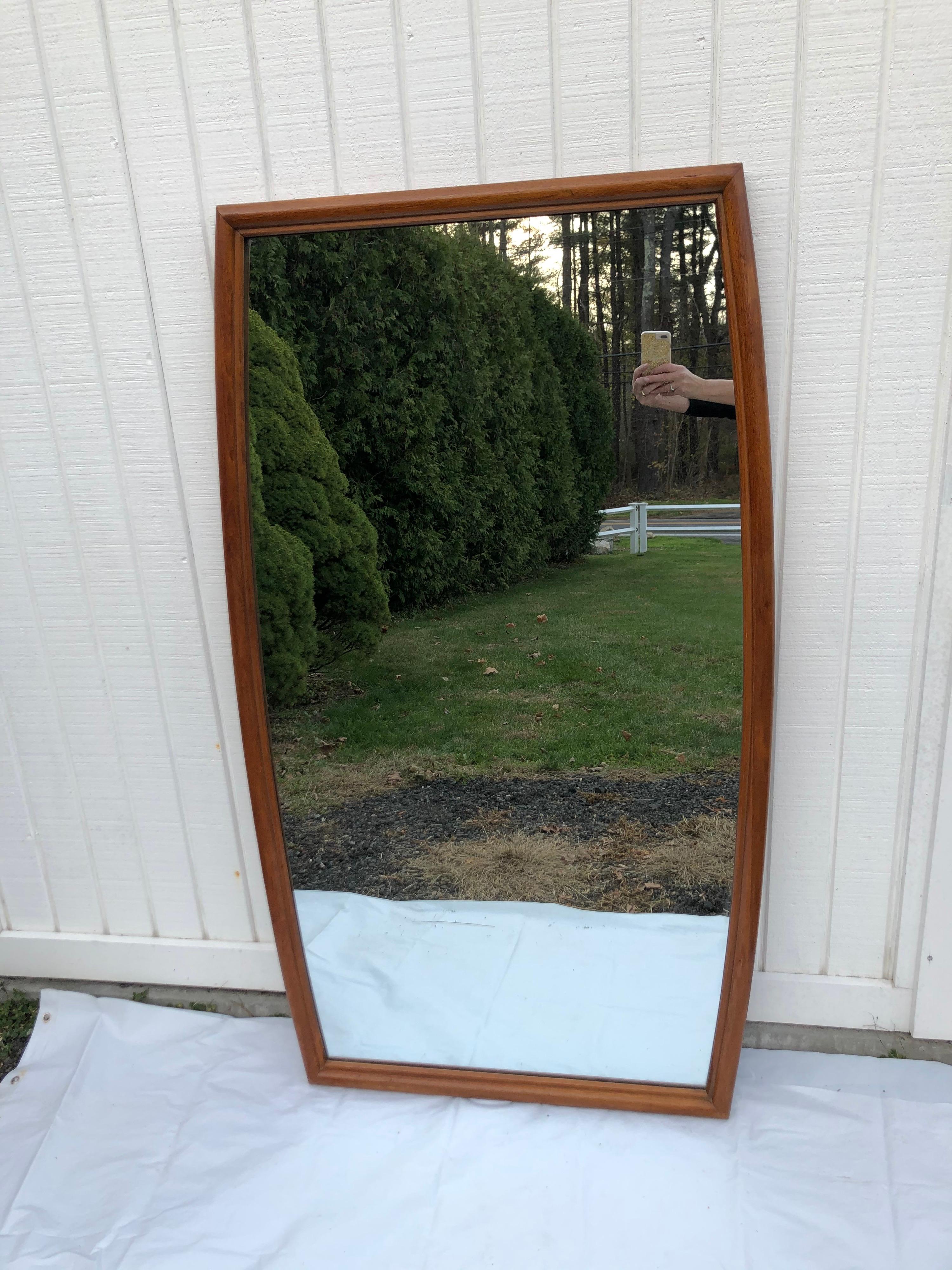 Large Mid-Century Modern mirror. Very large and unique in shape. Can be hung vertically or horizontally.
Light wooden tone. Mirror width at top is 28