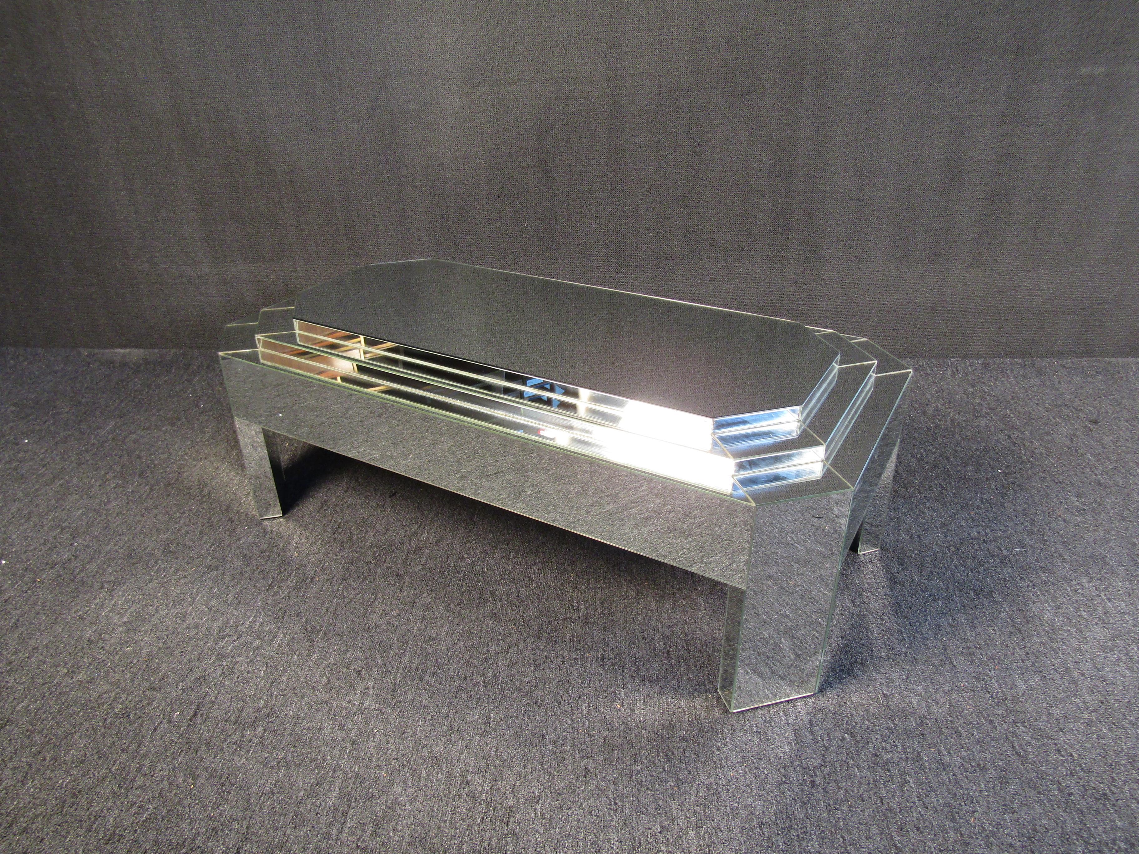 An incredible mirrored coffee table that can add bold Mid-Century Modern flair to any room. A reflective mirrored surface and geometric design offers a unique look. Please confirm item location with seller (NY/NJ).