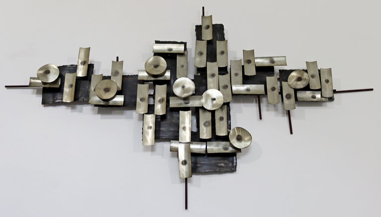 For your consideration is a beautiful, Brutalist, mixed metal hanging wall art sculpture, in the style of Curtis Jere, circa the 1970s. In very good vintage condition. The dimensions are 48.5