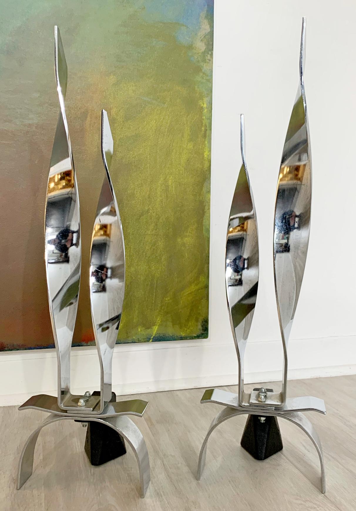 For your consideration is a gorgeous pair of polished steel andirons, table sculptures, made in Japan, circa the 1980s. In excellent condition. The dimensions of each are 7