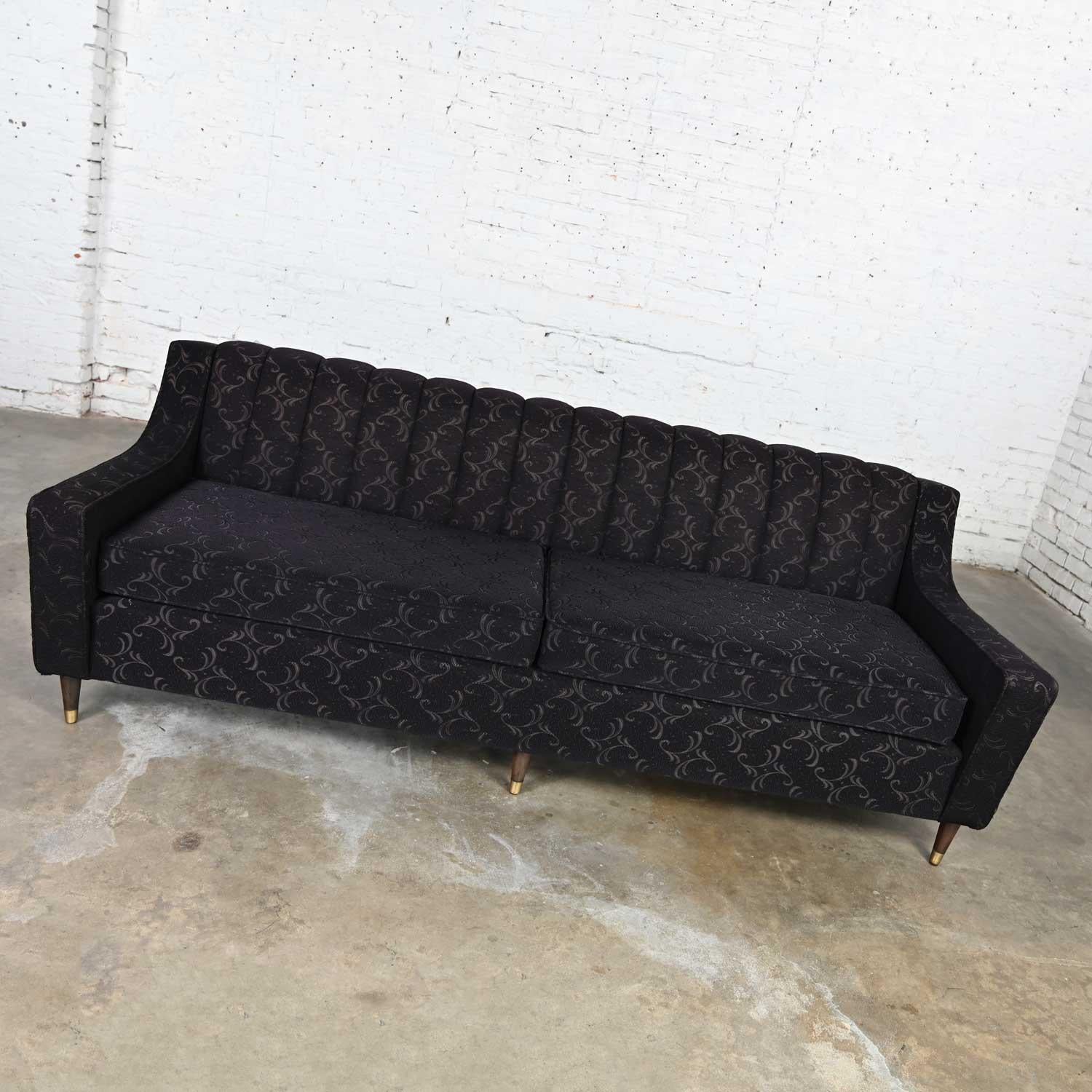 Stunning vintage mid-century modern modified Lawson style sofa with a channeled back, black frieze fabric, round tapered walnut legs and brass sabots. Beautiful condition, keeping in mind that this is vintage and not new so will have signs of use