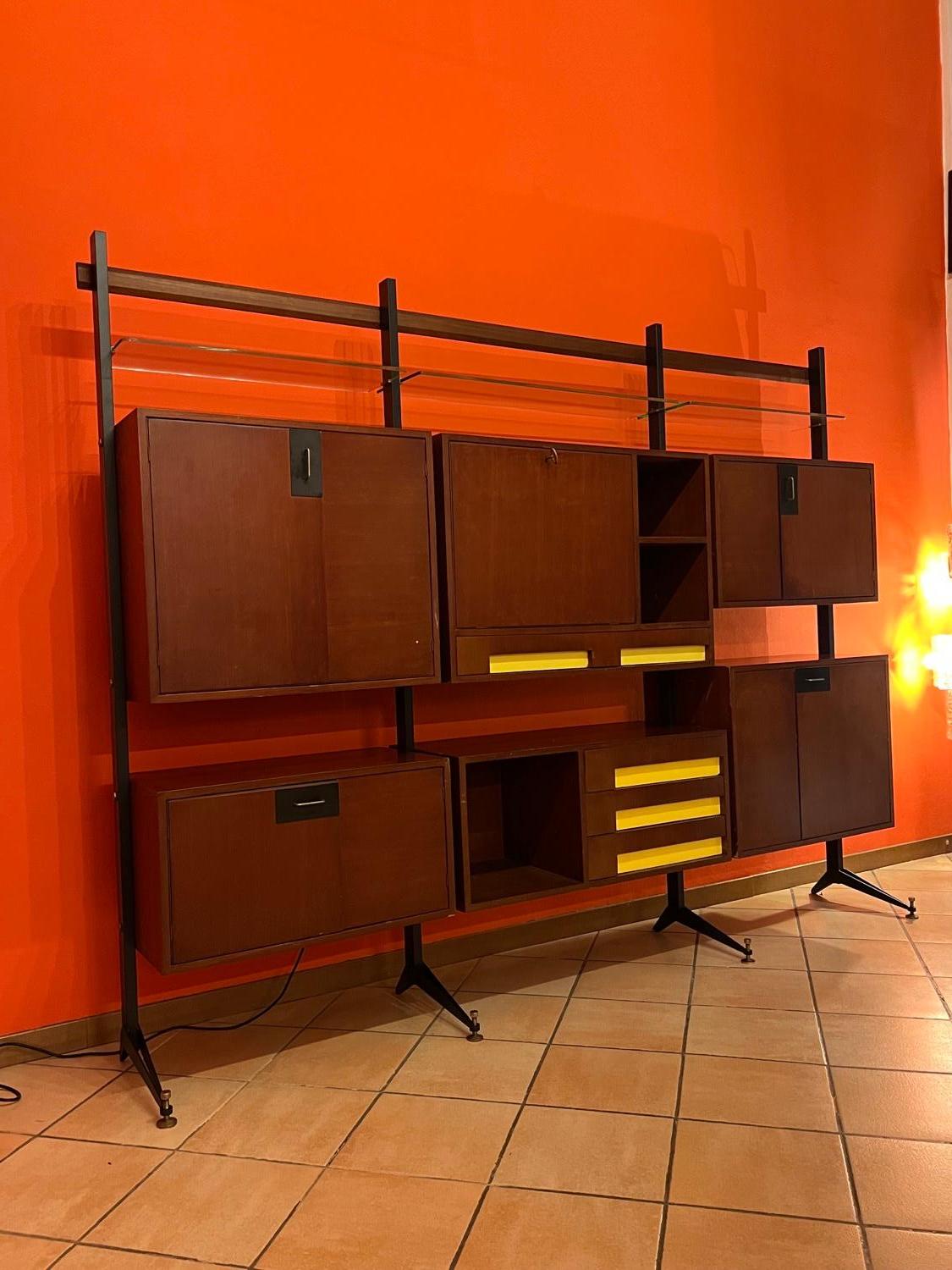 Vintage Mid-Century Modern modular bookcase in wood with metal main structure.

Designed and mady in Italy during the 1960s, this anonymous modular bookcase is a beautiful piece to bring immediate life and character to any interior. It consists of