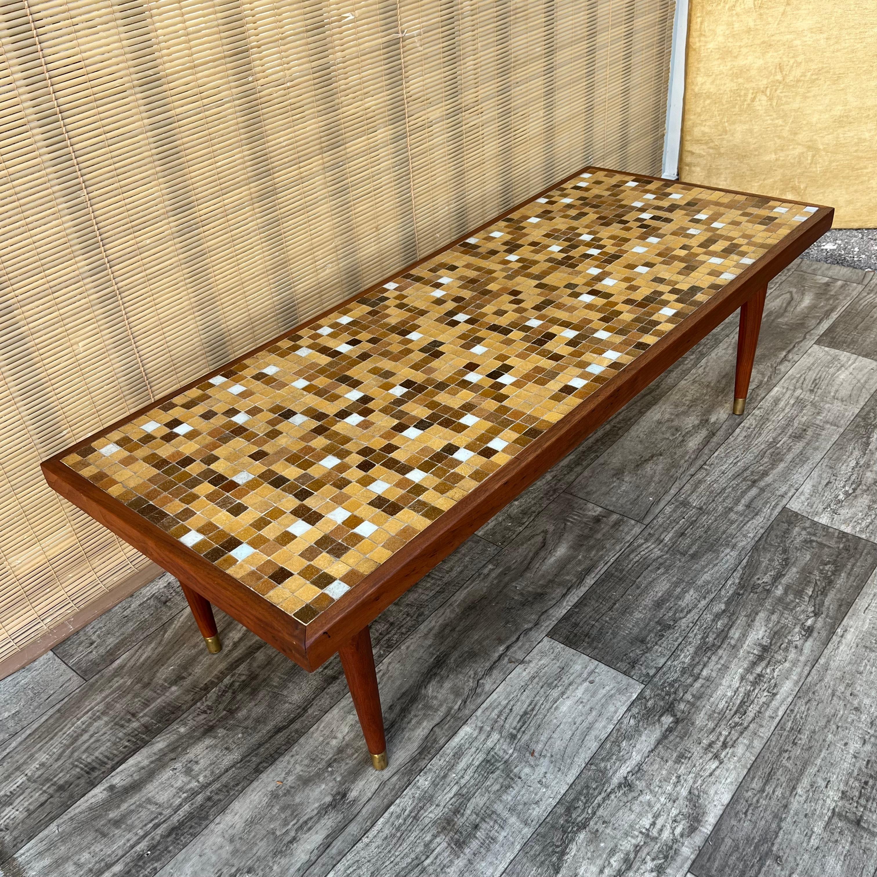 Vintage Mid Century Modern Mosaic Top Coffee Table in the Jane and Gordon Martz Style. Circa 1960s
Features a solid wood frame with an earth tones mosaic top, and removable tapered legs. 
In good original condition with minor signs of wear and age.