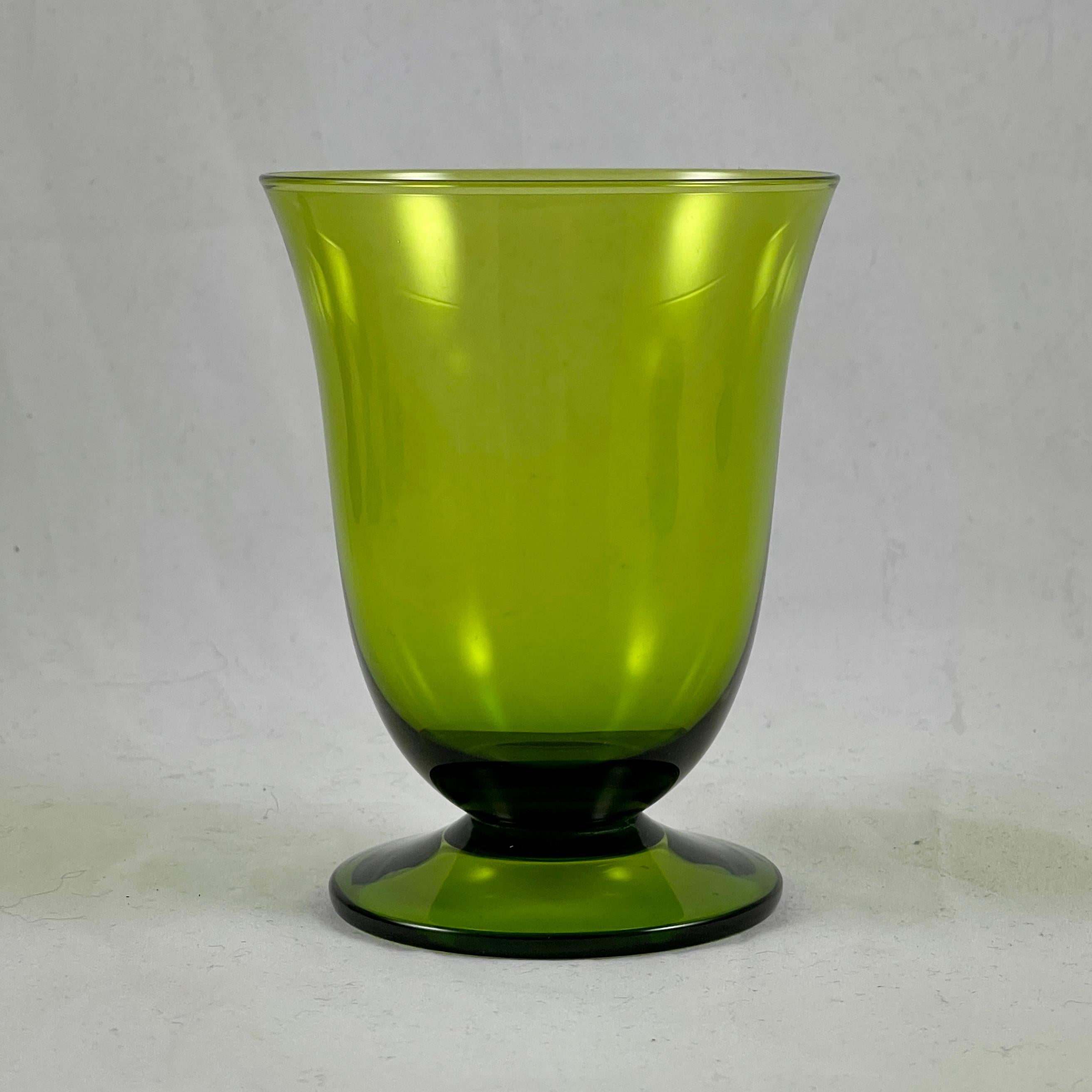 From the mid-century era, a set of ten low-footed goblets, circa 1960-1970.

In a moss or avocado green, a simple tapered wide mouth upper with a low footing. Ideal for wine, low ball cocktails or juices.

Measures: 4.25 in. Height x 3.5 in.