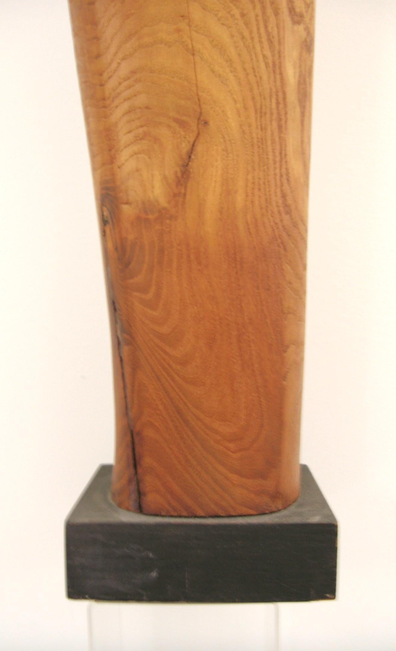Mid-Century Modern figurative Mother of Mary sculpture. Hand carved wooden Figure of the Madonna. Sits atop a darker base. This hand carved and turned wooden sculpture shows exceptional artisan craftsmanship. This will be a great addition to your