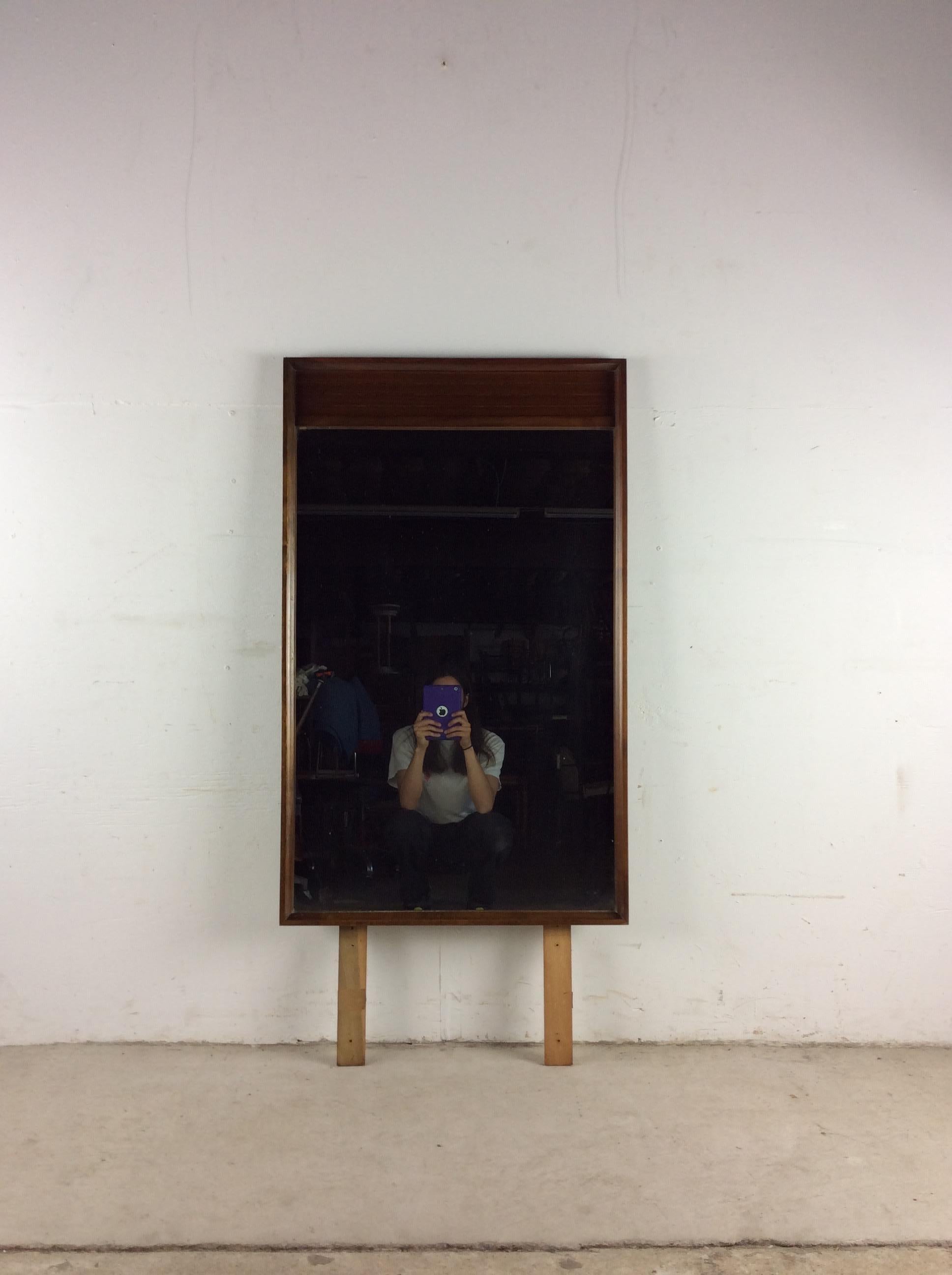 This mid century modern mirror features hardwood construction, original walnut finish, unique louvered walnut detail at the top, vintage mirrored glass, and two boards for mounting to a dresser or vanity.

Dimensions: 25.25w 1.5d 41.25h

Condition: