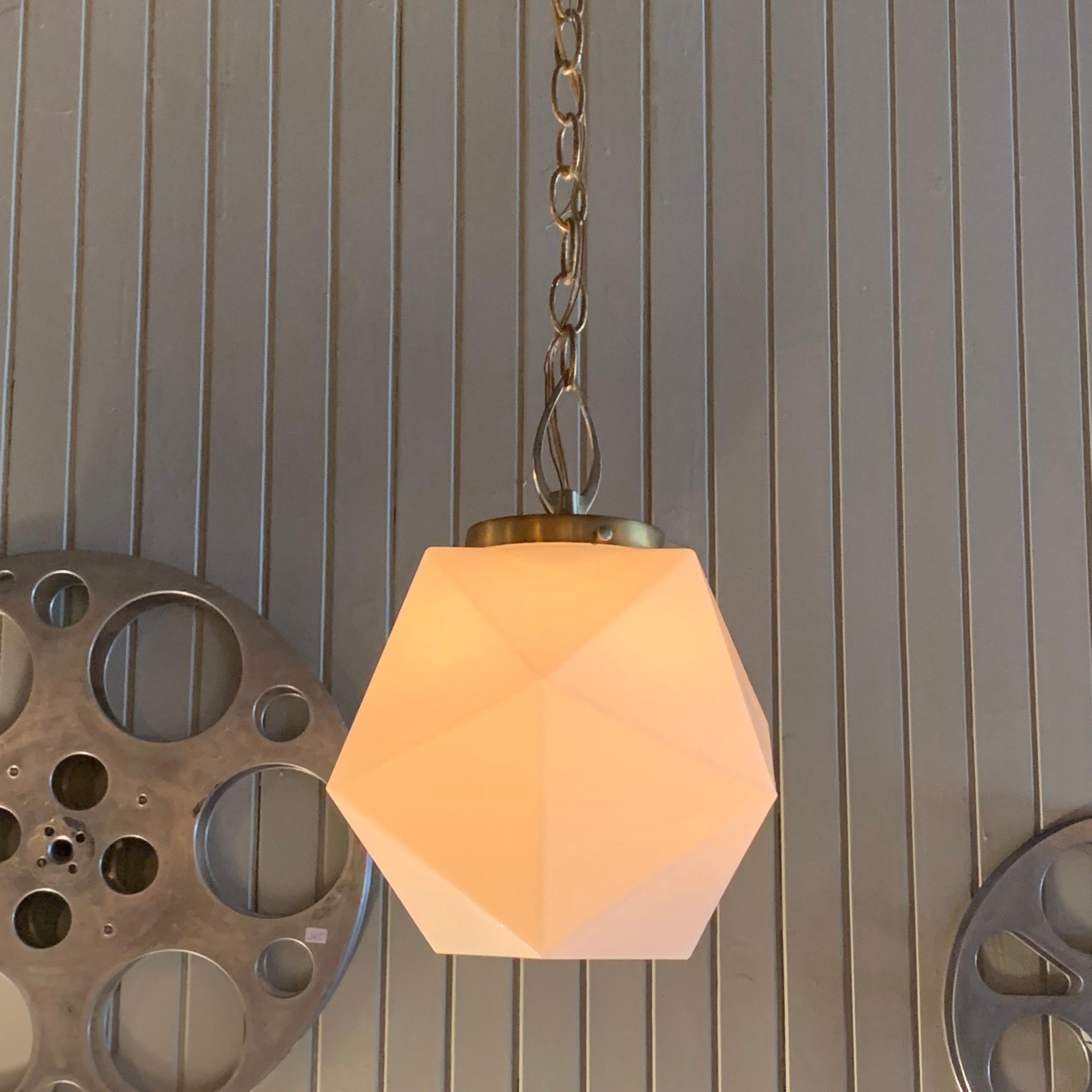 Mid-Century Modern, multifaceted, milk glass pendant light with brass is newly wired with 48 inches of brass chain to accept up to a 150 watt bulb.