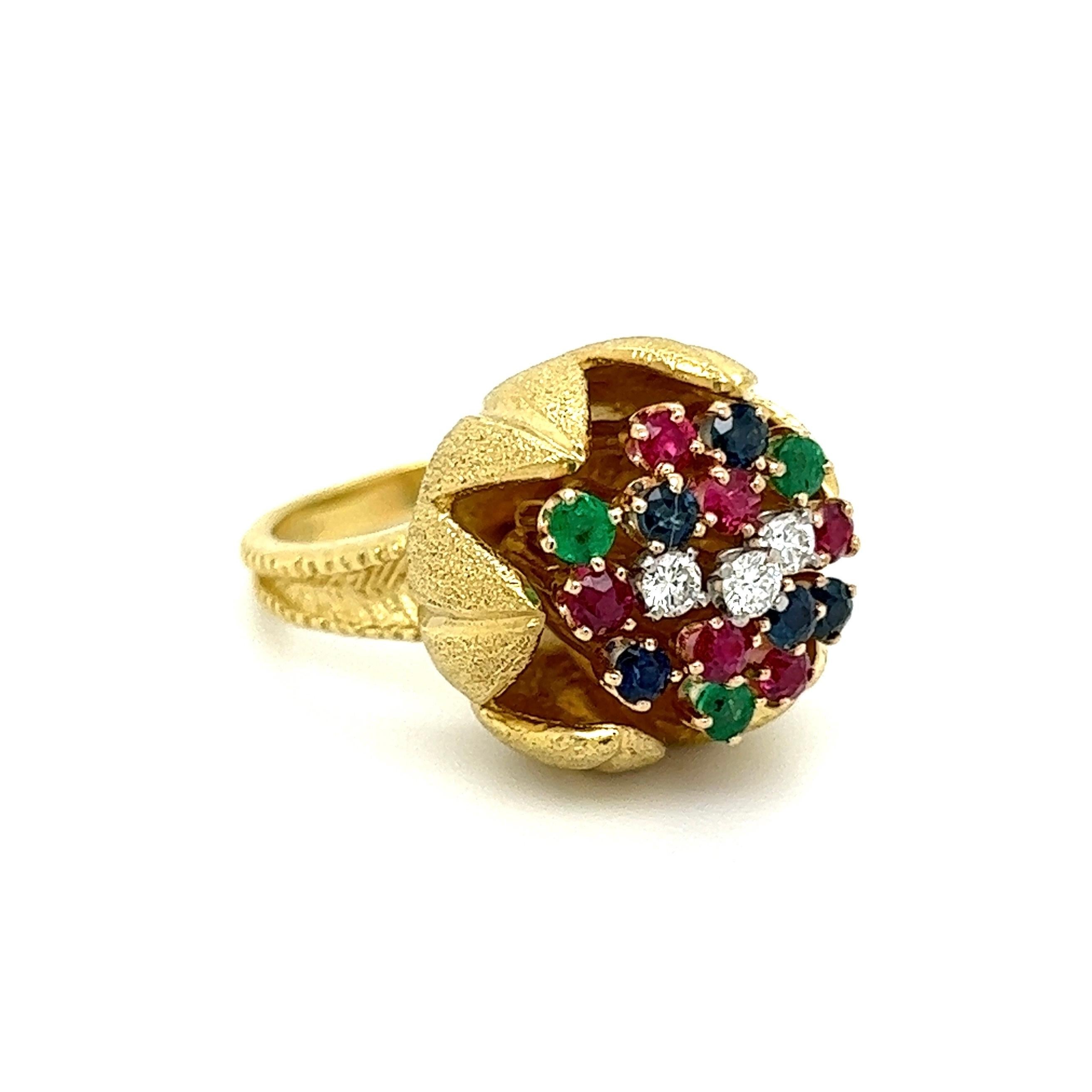 Simply Beautiful! Multi Gem and Diamond Gold Cocktail Ring. Centering a Hand set securely nestled Cluster of Rubies, Emeralds, Sapphires and Diamonds. Beautifully Hand crafted 18K Yellow Gold mounting. Approx. Dimensions of the ring: 1.26