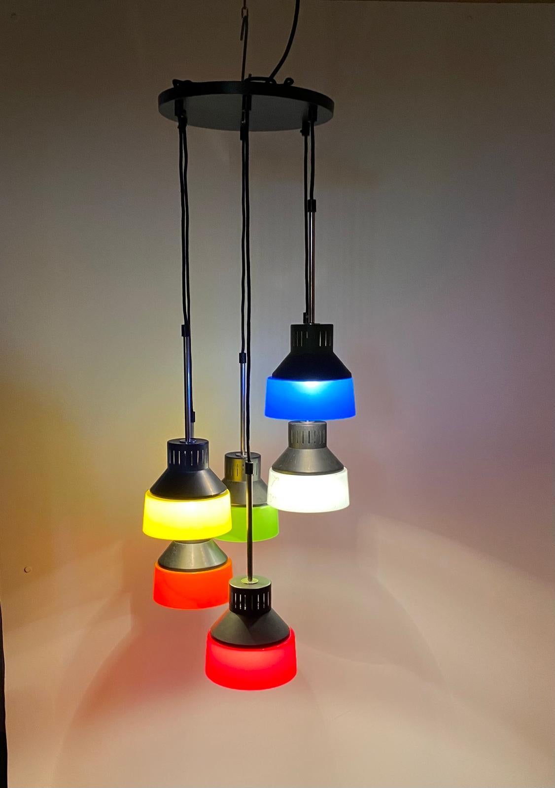 Mid Century Modern Italian Cascade Chandelier.

This Cascade chandelier, manufactured in Italy during the 1960, features six hanging light spots made of iron, the chandelier is adorned with vibrant multicolor plastic lampshades that create a dynamic