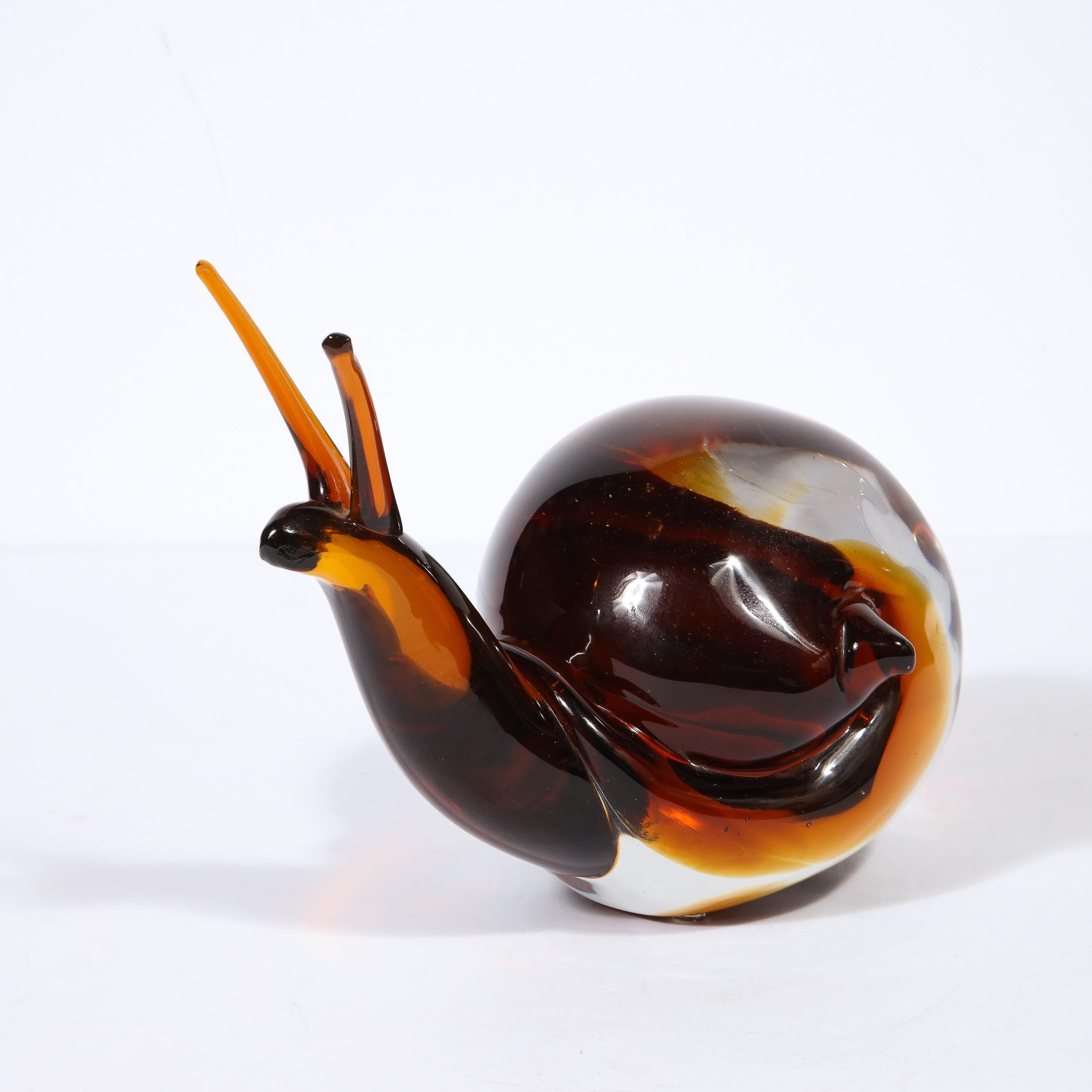 This sophisticated and whimsical glass snail sculpture was realized in Murano, Italy- the island off the coast of Venice renowned for centuries for its superlative glass production, circa 1970 by the esteemed 20th Century artist Licio Zanetti. Here,