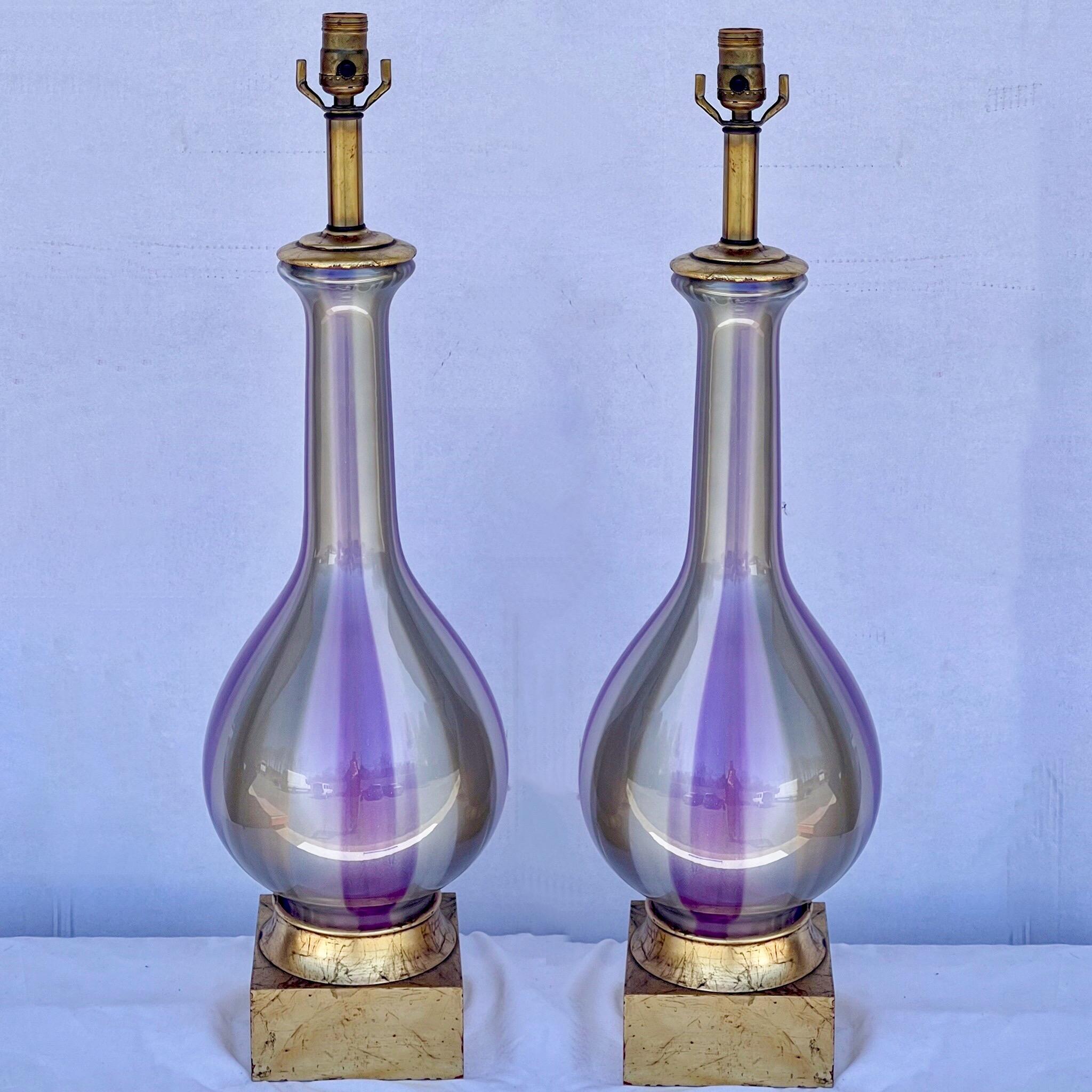 These are amazing! This is a pair of hand blown glass lamps with giltwood bases attributed to Murano. The bases are 6” square. The height to the finial is 44 inches. They are in very good condition.