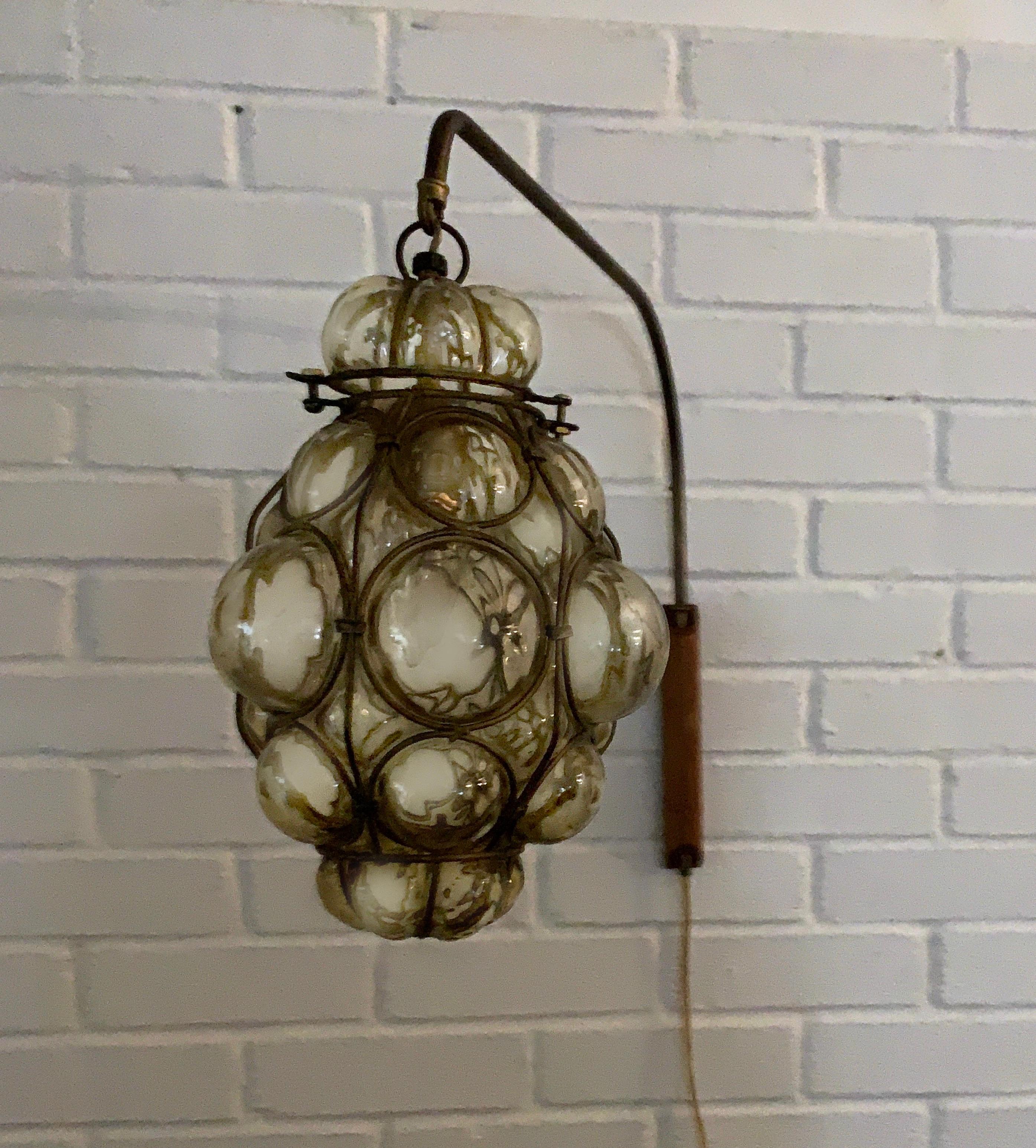 Mid-Century Modern Murano caged glass wall light, sconce, reading lamp, 1960s. Rare swinging wall lamp set up, gorgeous park aged metal neck with wood wall support.