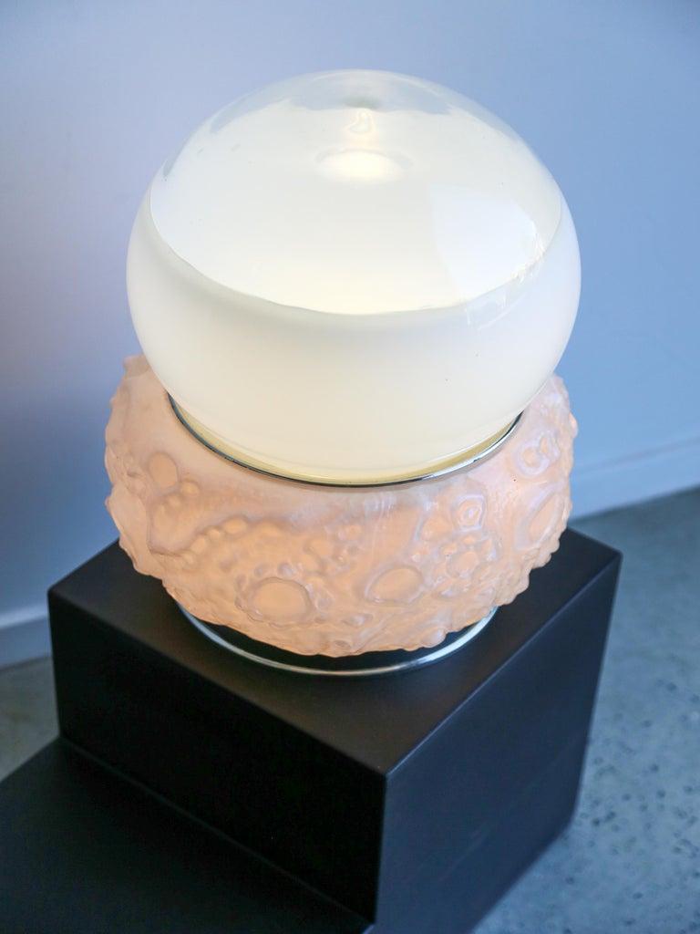 Osso ( bone ) table lamp by Mazzega.

Mazzega is an Italian glass company known for its beautiful and artistic glasswork, particularly in the field of Murano glass. Murano glass is a renowned type of glass that originates from the island of Murano,