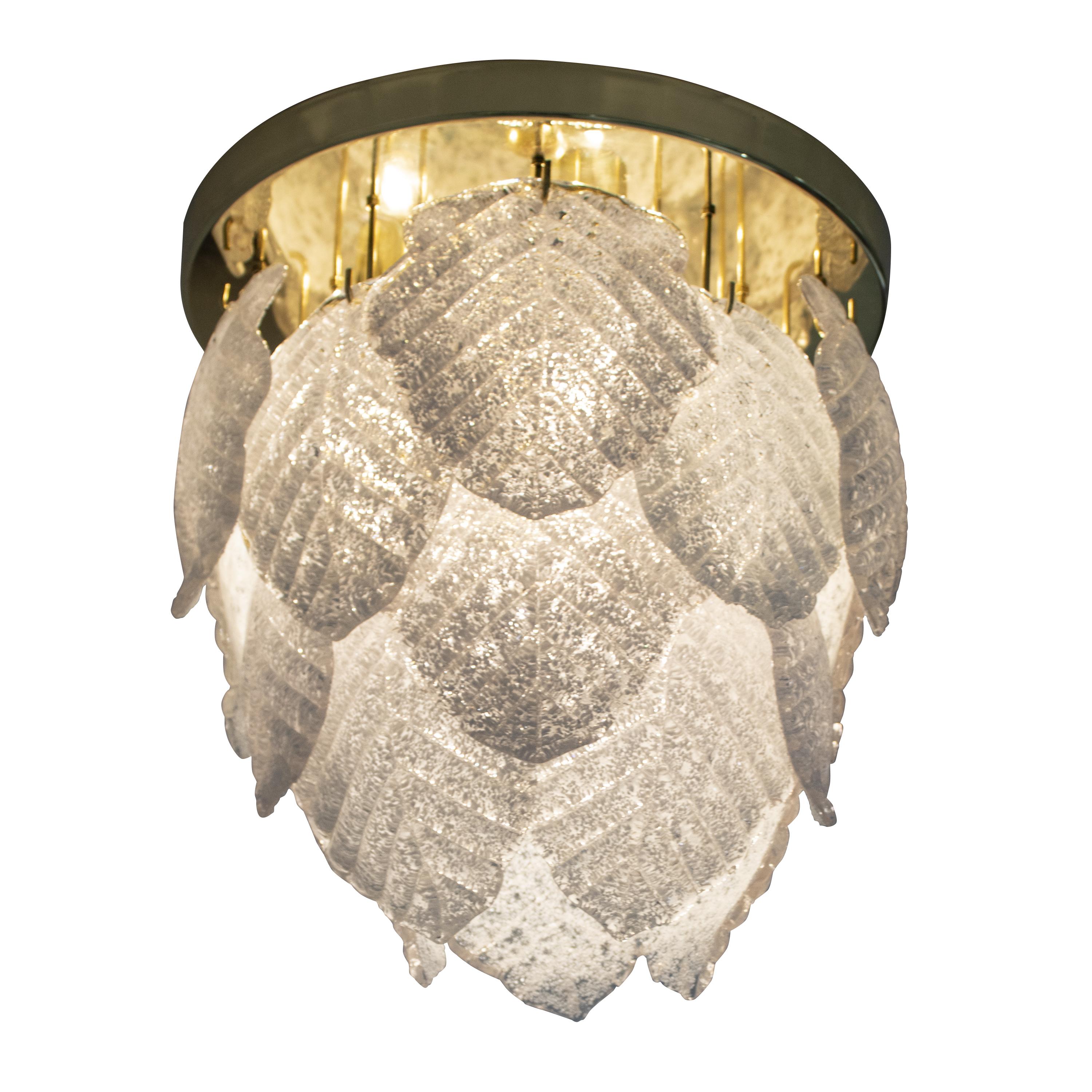 Italian Suspension chandelier lamp composed of 4 light sources on an oval brass metal structure. The lamp consists of hand craved and hand-molded white Murano glass in the shape of organic leaves.
 