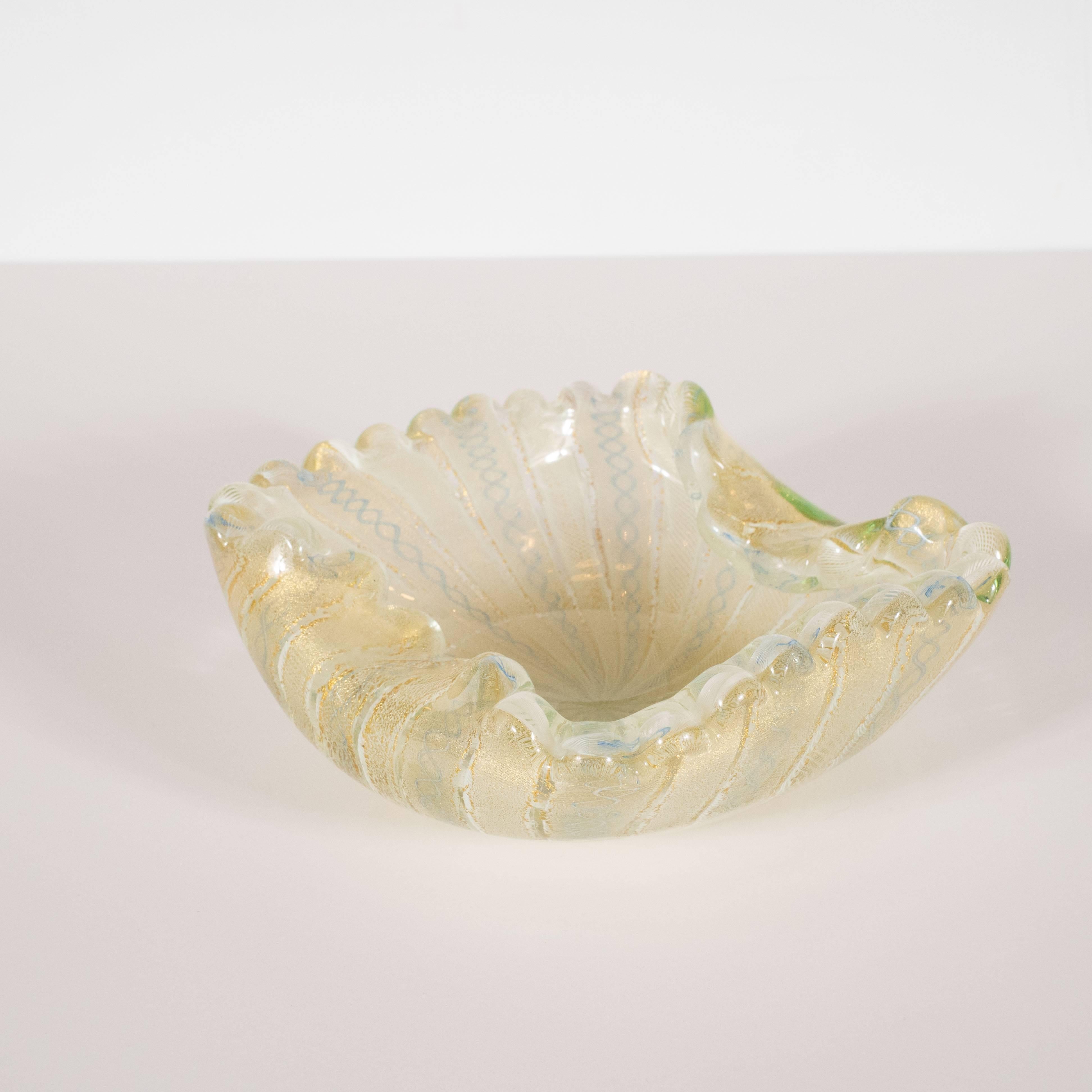 This stunning Mid-Century Modern decorative bowl was hand blown in Murano, Italy- the islands off the coast of Venice, renowned for centuries for their superlative glass production, circa 1950. It features scalloped edges; two sinuously curved