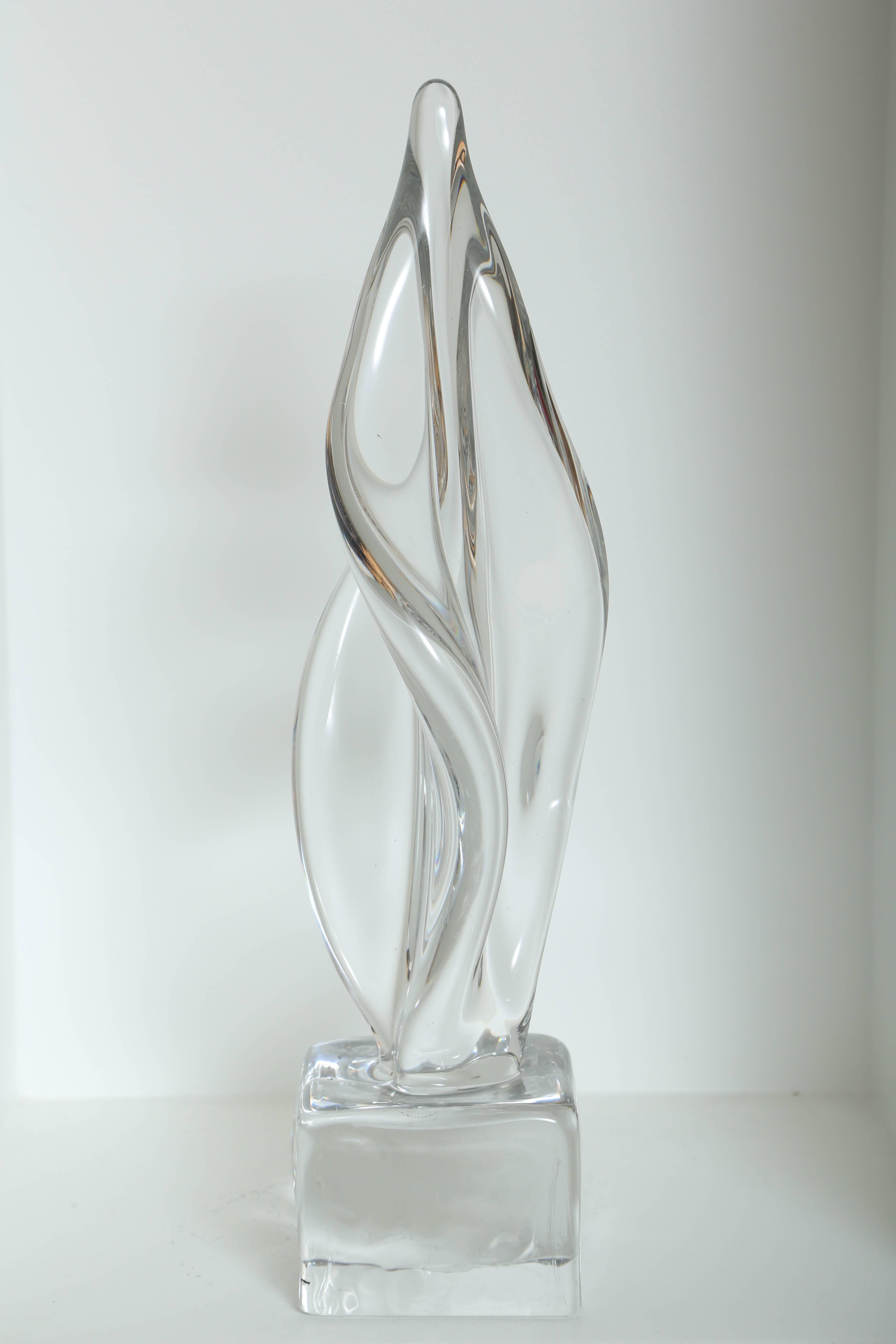 Vintage large abstract sculpture in handblown clear cast Murano glass. Sculpture has spiral form with amorphous design reminiscent of a fire flame, and features square solid glass pedestal base.