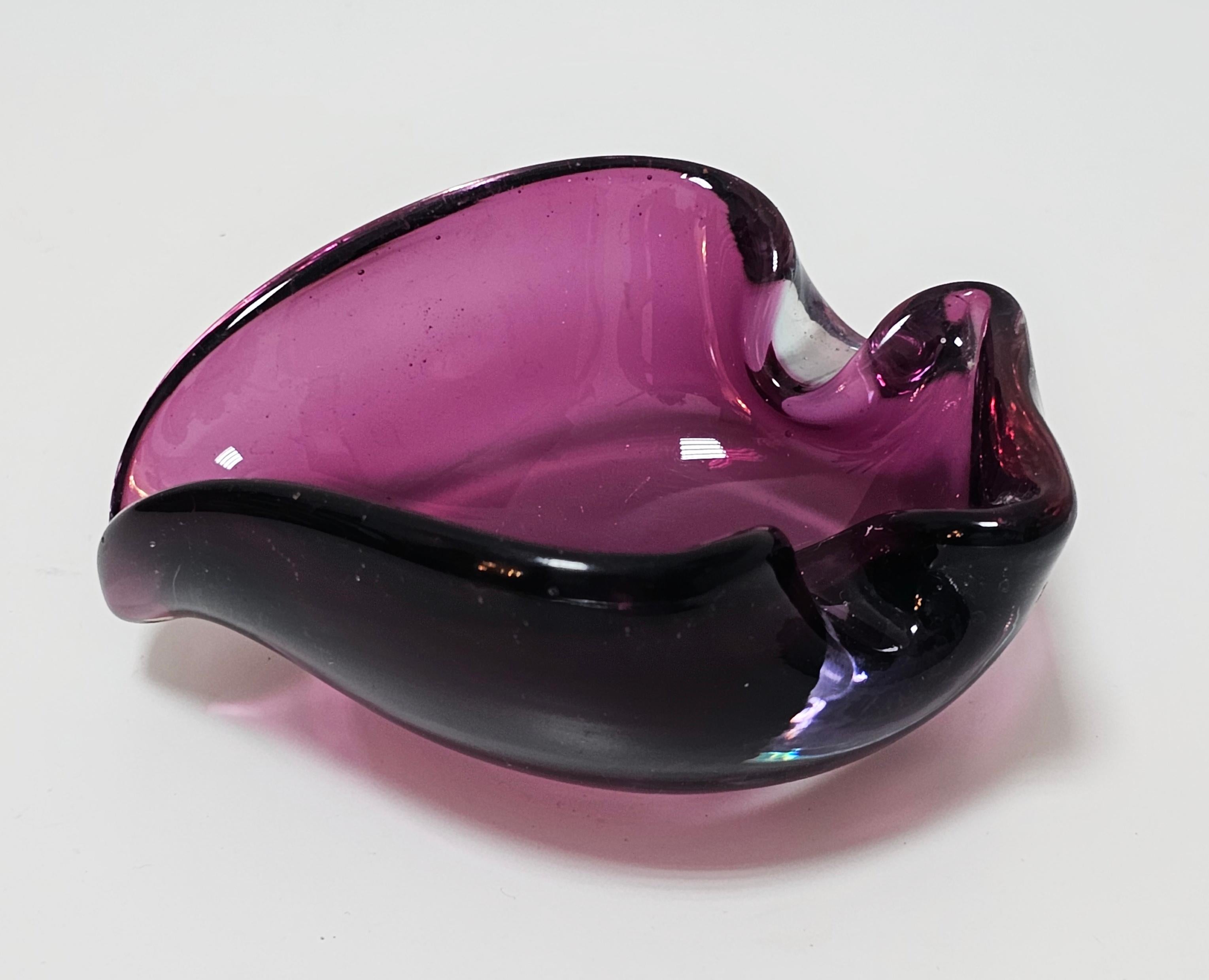In this listing you will find a gorgeous Mid Century Modern Purple Murano glass ashtray, done in style of Alfredo Barbini. It features beautiful shape with two rests for the cigarettes. Made in Murano in 1960s.

Excellent vintage condition. No