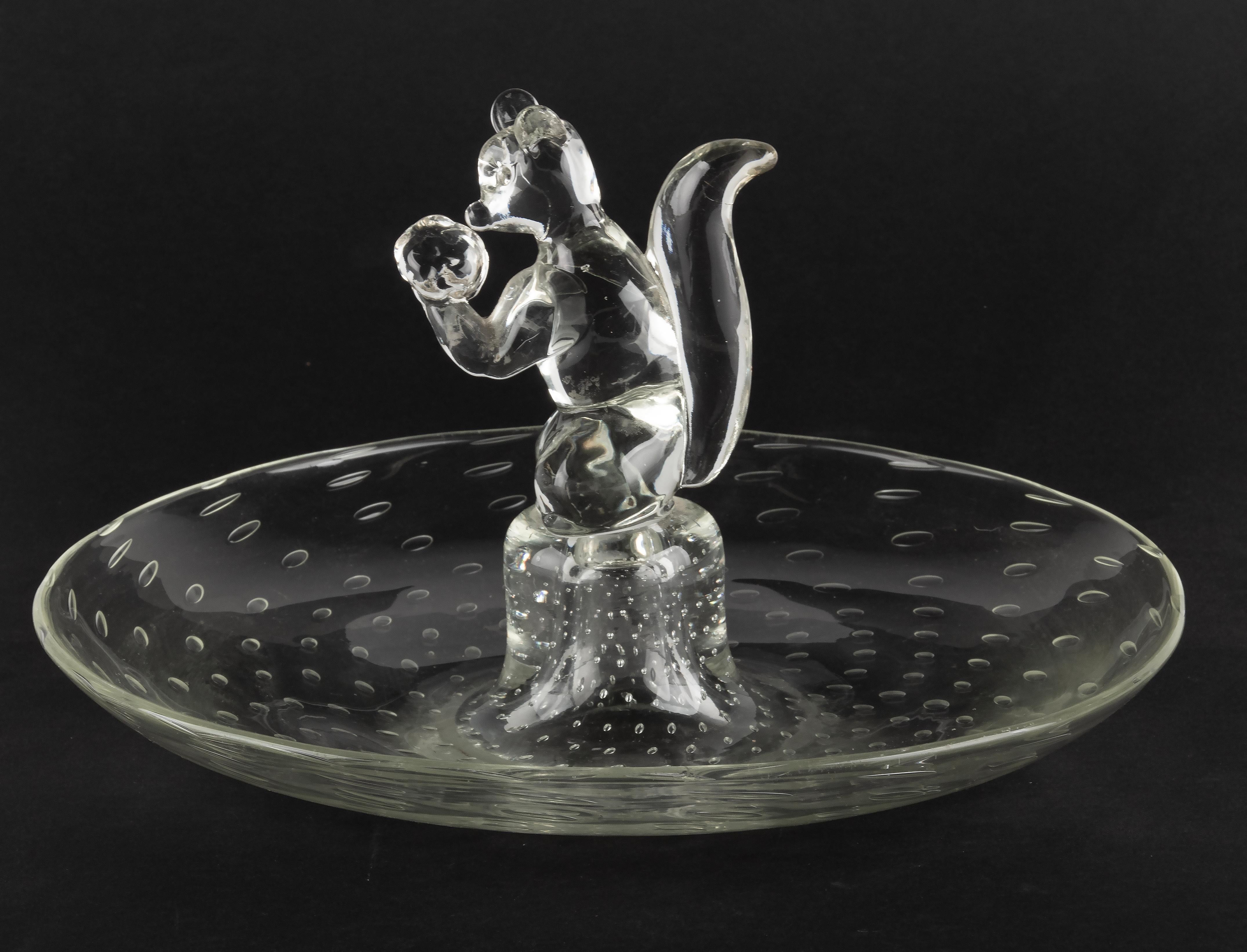 Large Mid-Century Modern Murano glass serving bowl. In the middle a figure of a squirrel. The glass is clear in color with bubble inclusions. A great piece for serving all sorts of nuts. The dish is in good condition, only some scratches on the