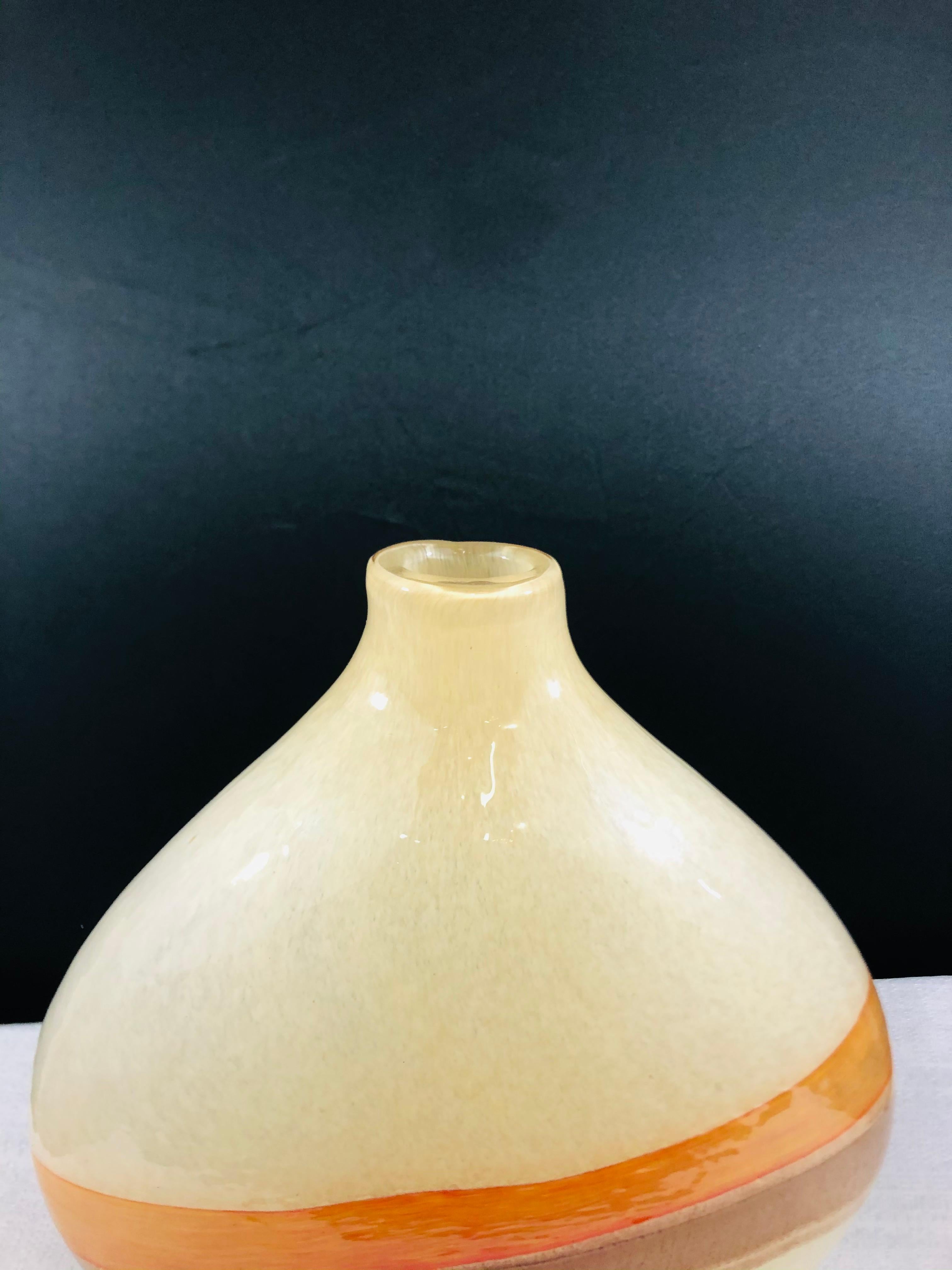 An elegant Mid-Century Modern Murano glass decorative vase in beige tone with brown and orange stripe design. This vase will add a touch of style to any space.

Measures: 12