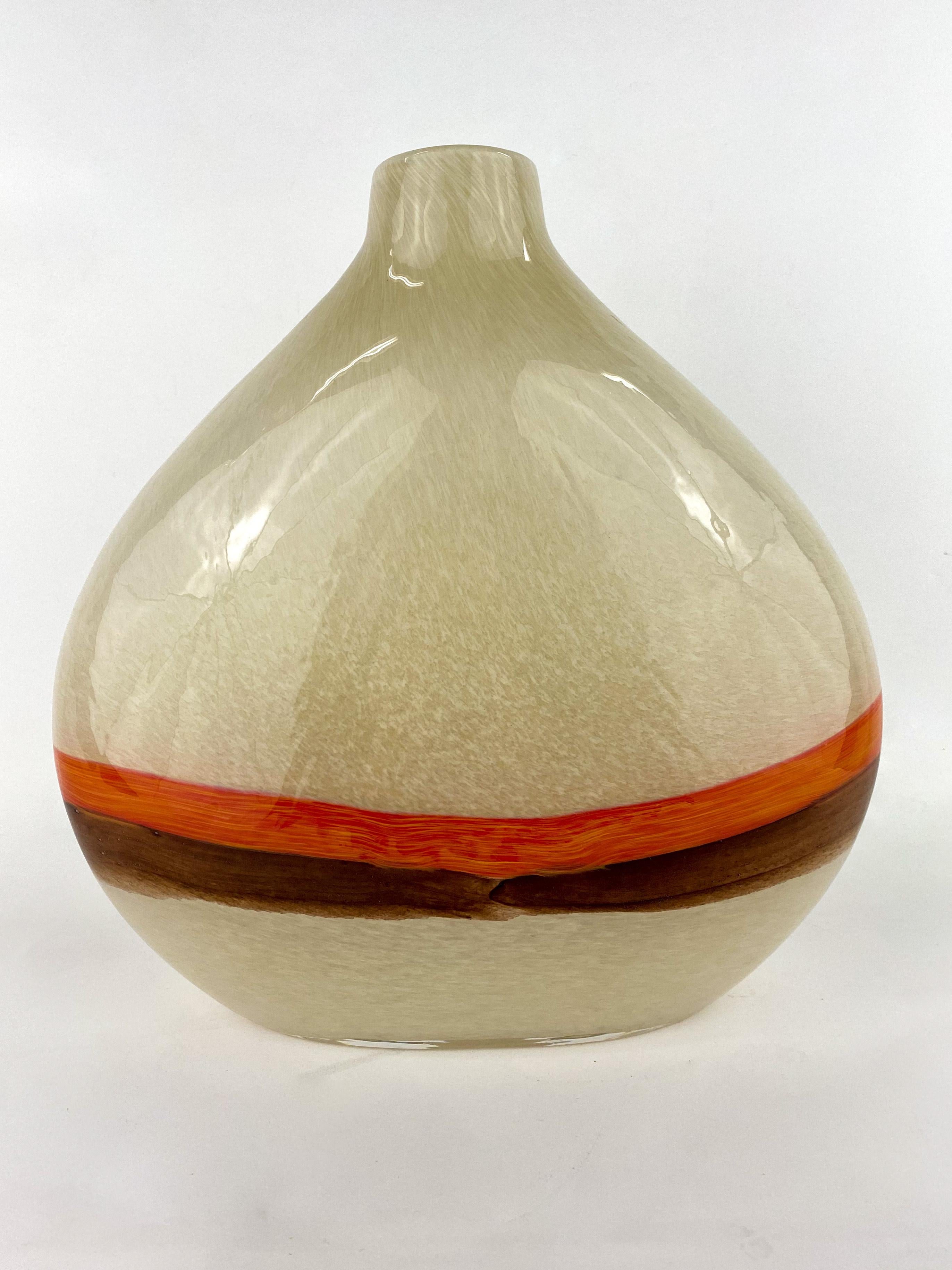 An elegant Mid-Century Modern Murano glass decorative vase in beige tone with brown and orange stripe design. Very stylish and featuring earthy tones, this vase will add a touch of style to any space.

Dimensions: 12