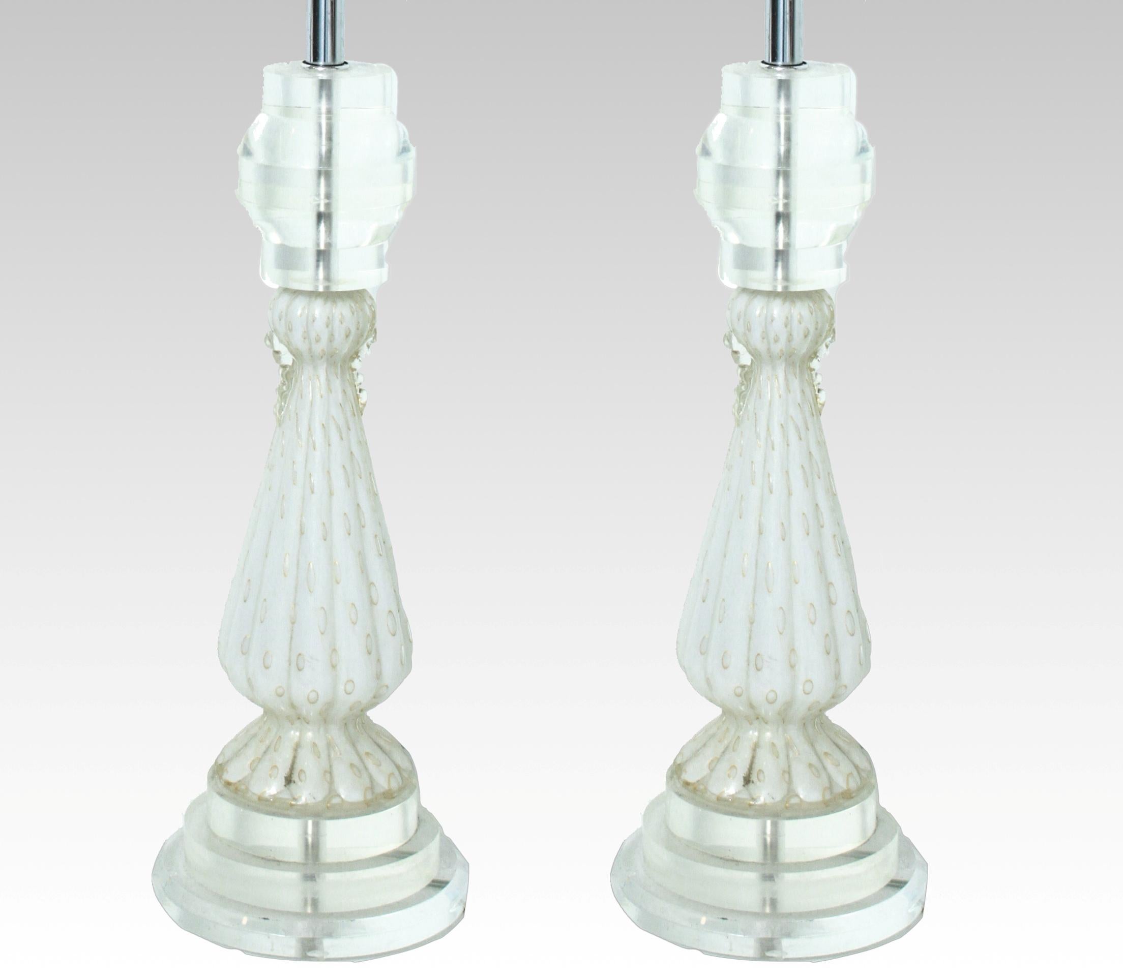 Mid-Century Modern pair of Italian Murano white and aventurine art glass table lamps with Lucite bases and tops. The pair comes with Lucite finials. In great vintage condition with age-appropriate wear and use.