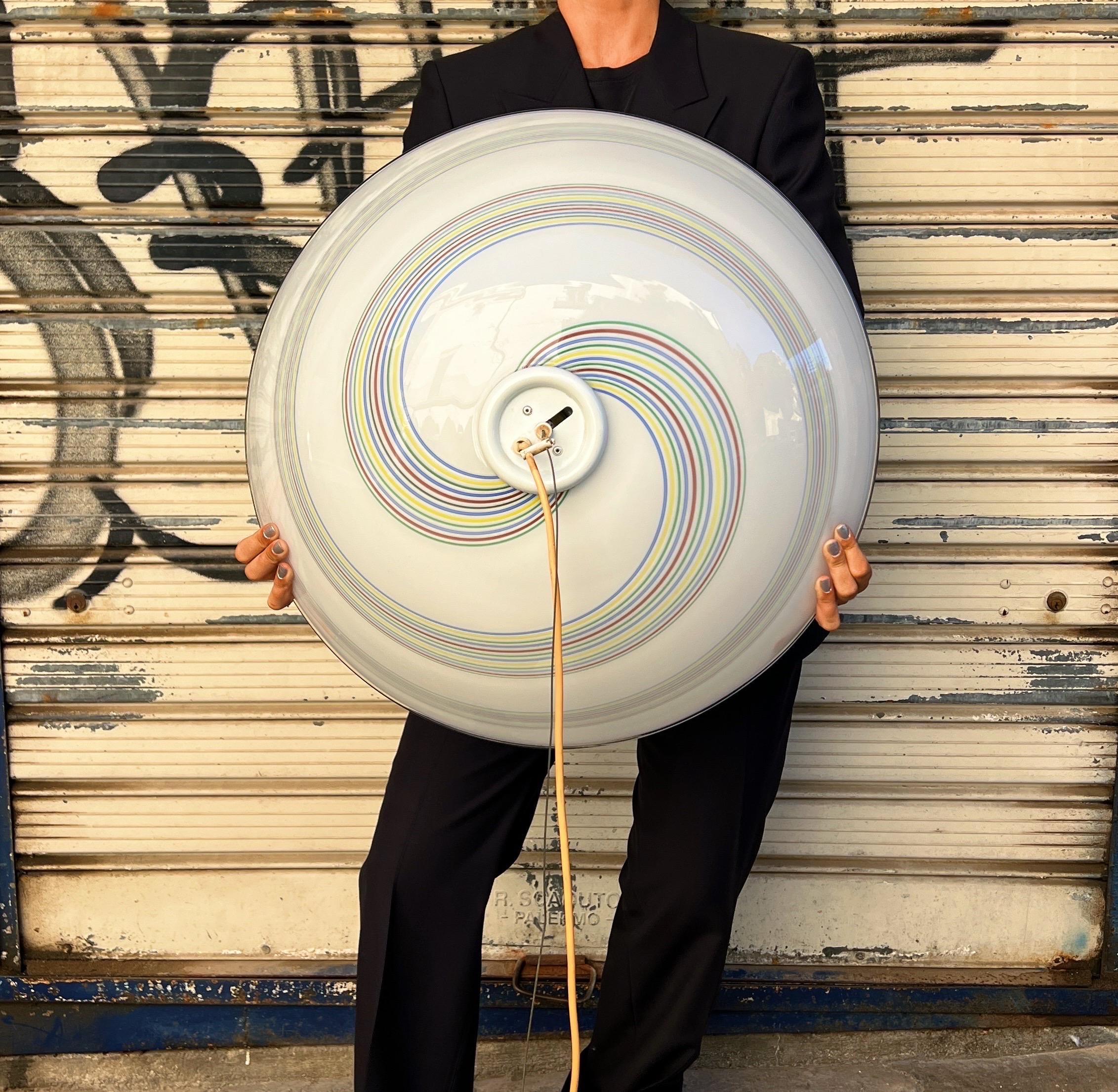 This stunning pendant light features an adjustable design, allowing you to customize the height to suit your ceiling. The light showcases a beautiful, multicoloured swirl pattern, predominantly visible on the top of the Murano glass. It is designed