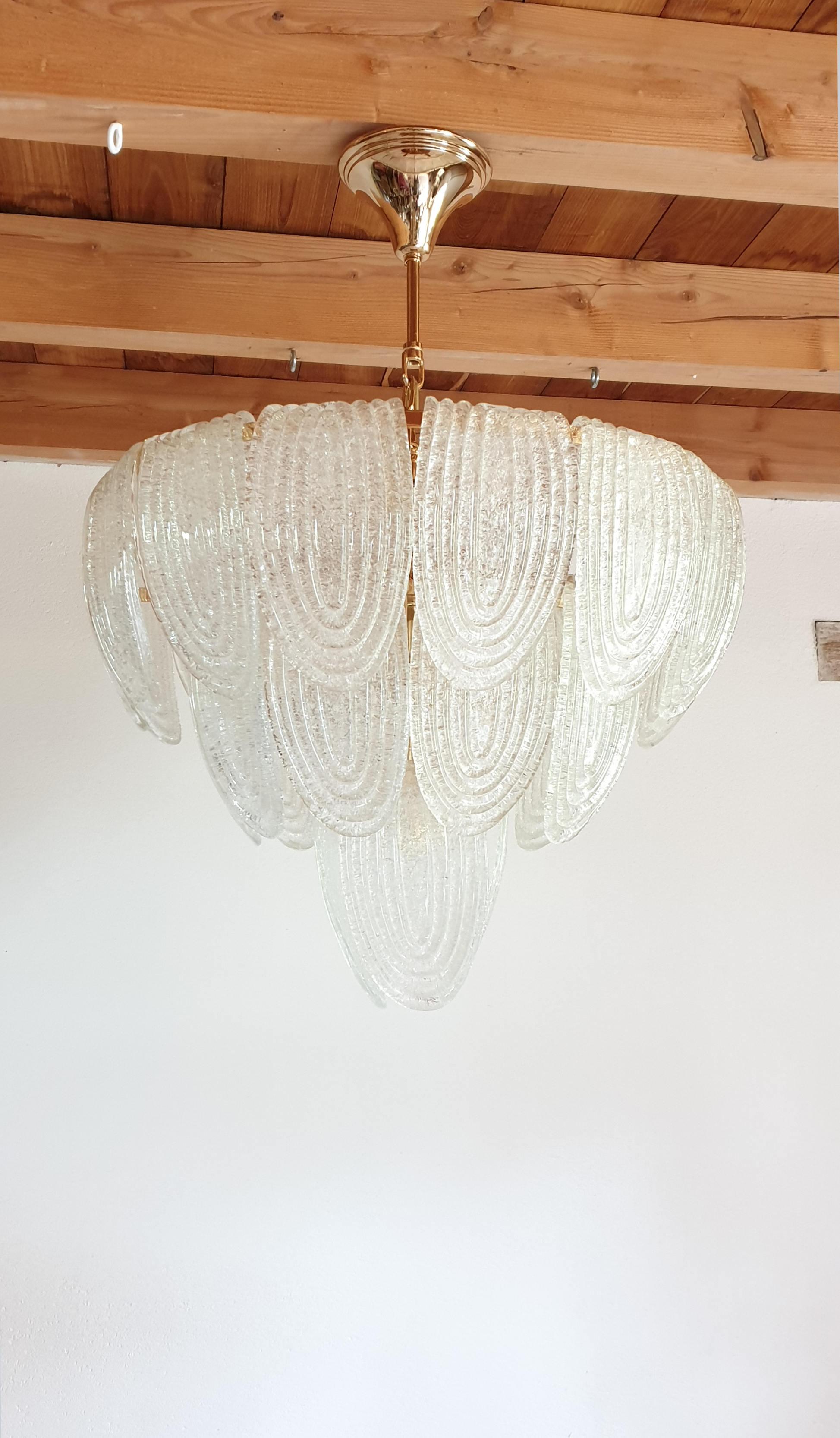 Large Mid-Century Modern translucent and textured Murano glass chandelier, with gold plated frame.
Can be hanged as a flush mount fixture, or like a chandelier, 
with a gold plated chain and canopy: total Height 43.68 in.
Height glass with canopy