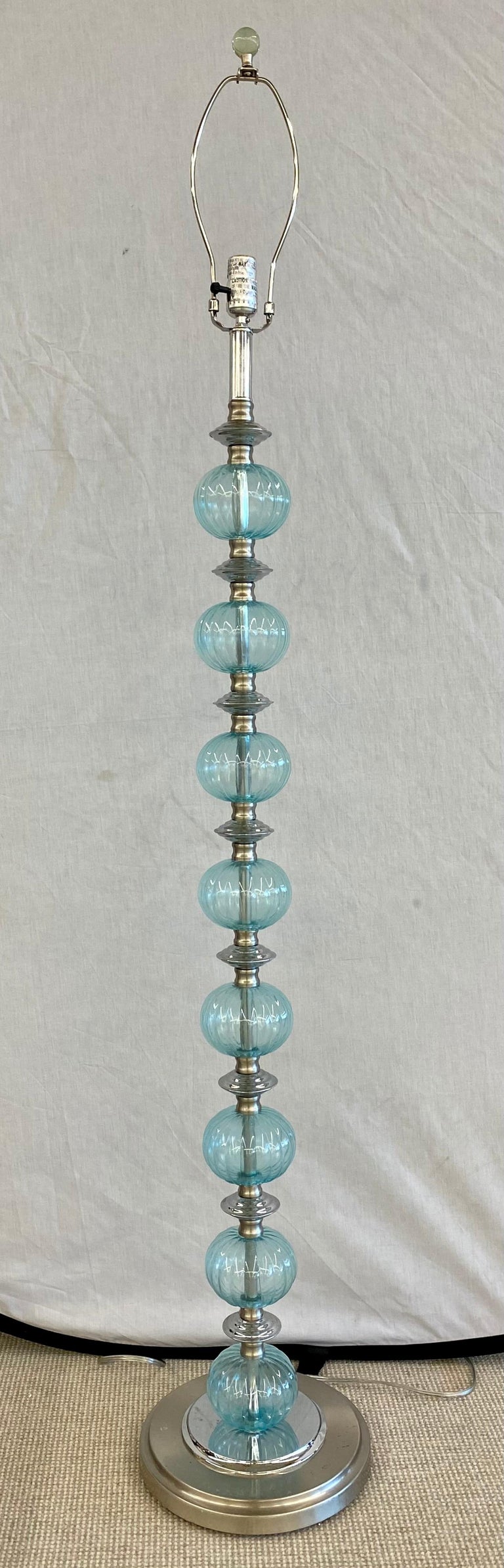 Mid-Century Modern murano glass standing floor lamp compromised of 8 murano glass blue tinted globes separated by a chrome column form center pole with chrome disks between each circular globe.
