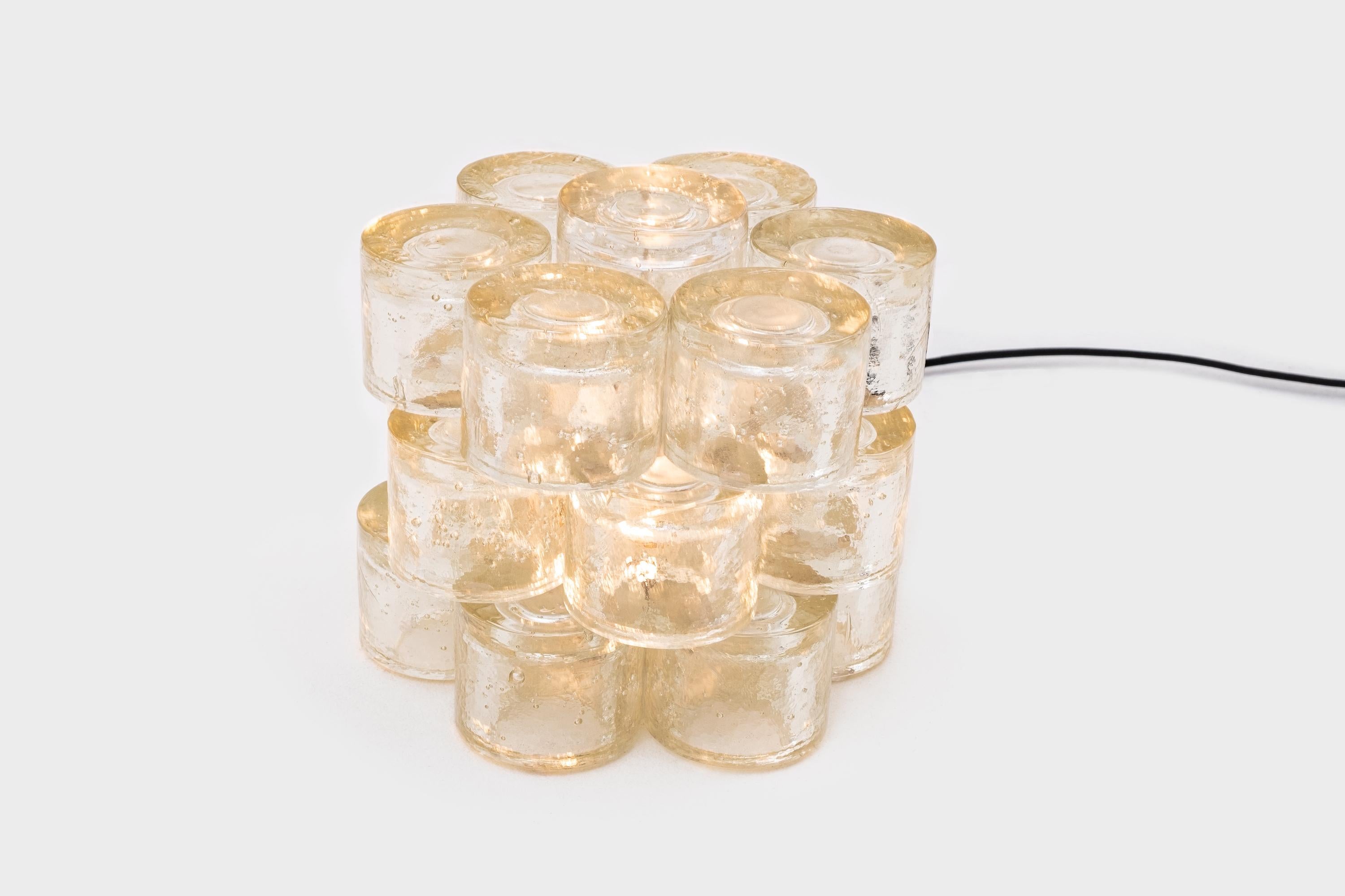 Exceptional table lamp by Poliarte, Italy, 1968. Big sculptural object made from heavy stacked Murano glass cylinders all handcrafted with each their own unique bubble pattern. Provided with one E27 light fitting for a balanced overall light, lamp